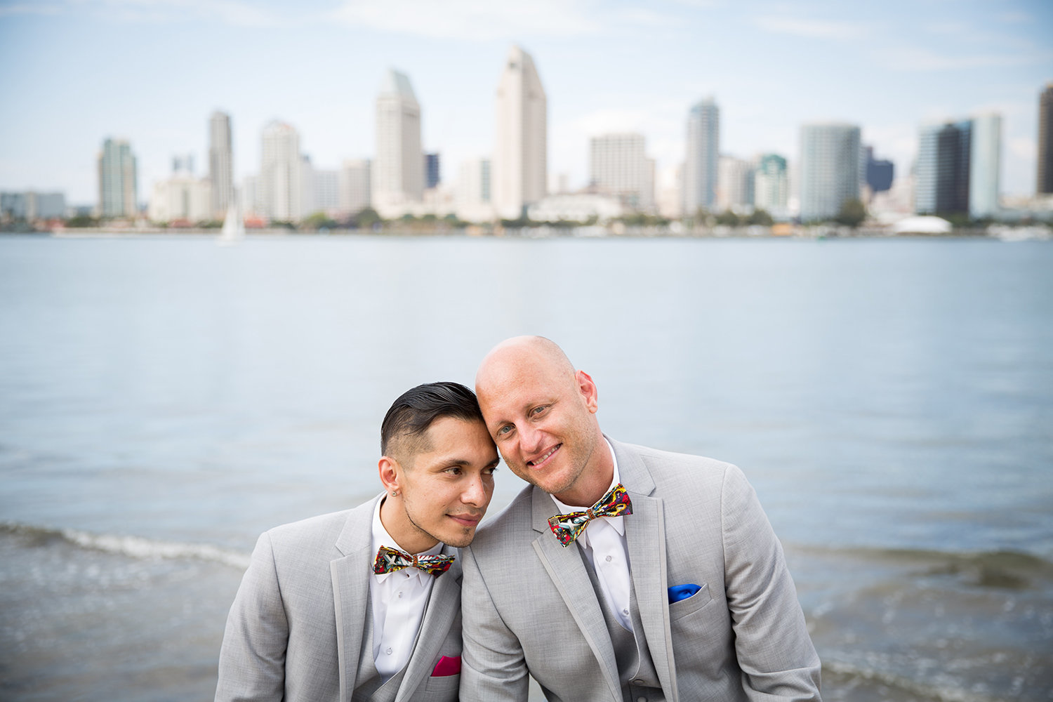 Portrait of a sweet gay couple with the San Diego skyline as the backdrop\