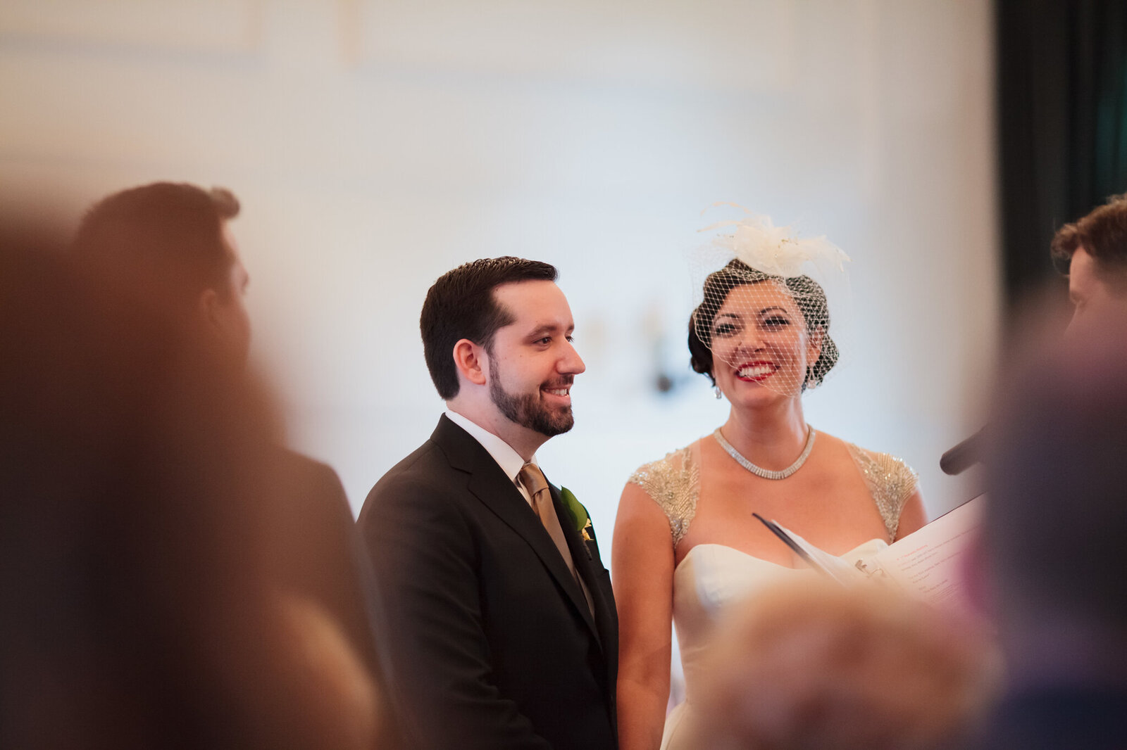 Bride and groom smile during wedding ceremony