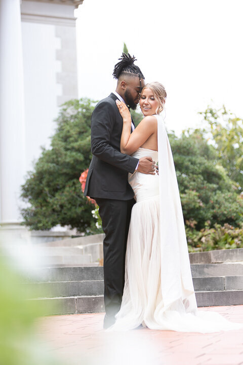Romantic moment between newlyweds at their wedding at hills-and-dales in la grange georgia 