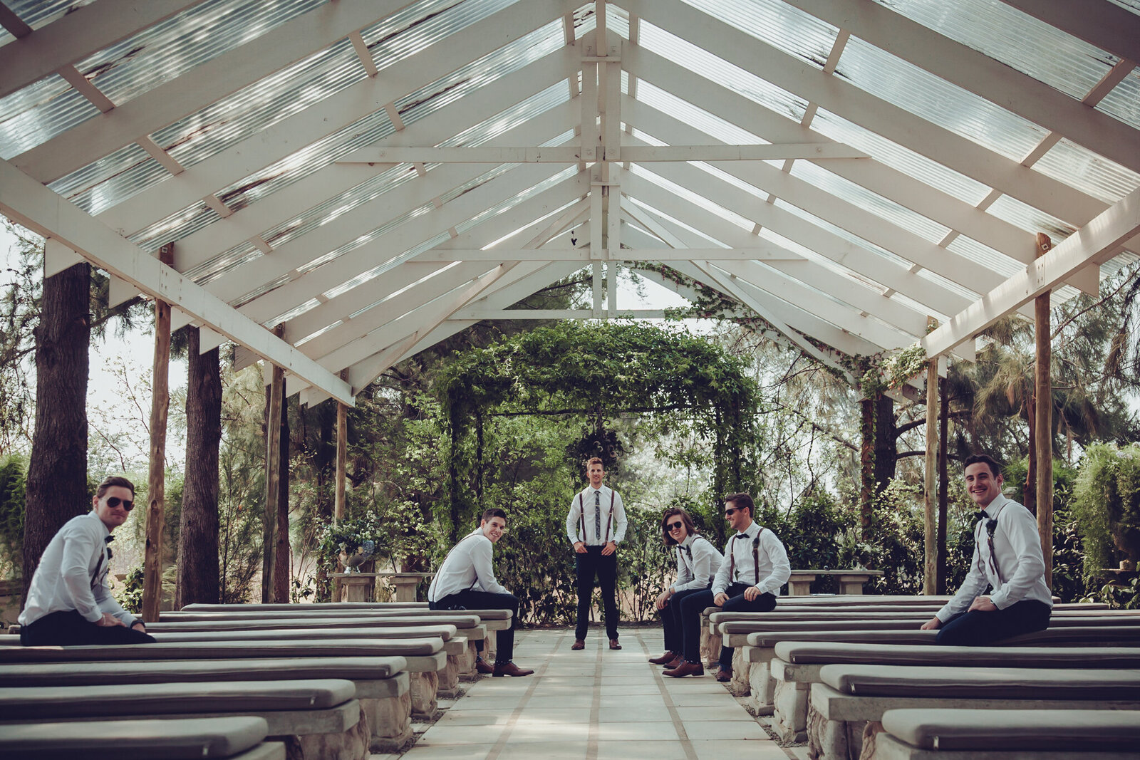 Groom and groomsmen portrait in the chapel at The Forum White Light.