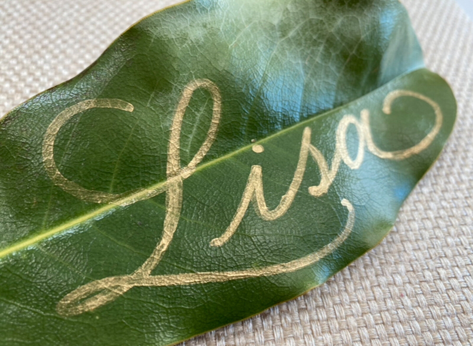 Place card calligraphy on a green leaf