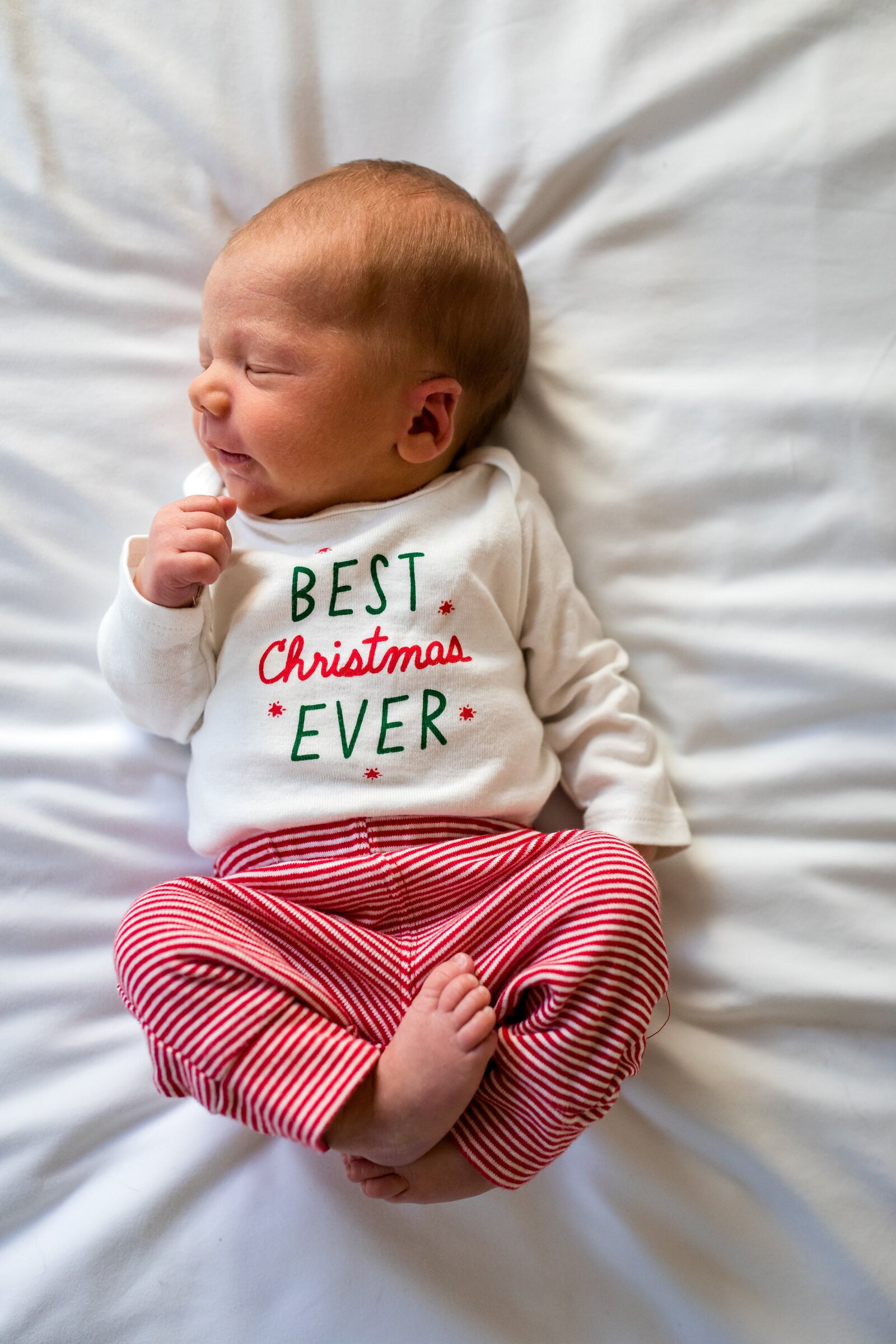 One week old baby in  Best Christmas Ever outfit