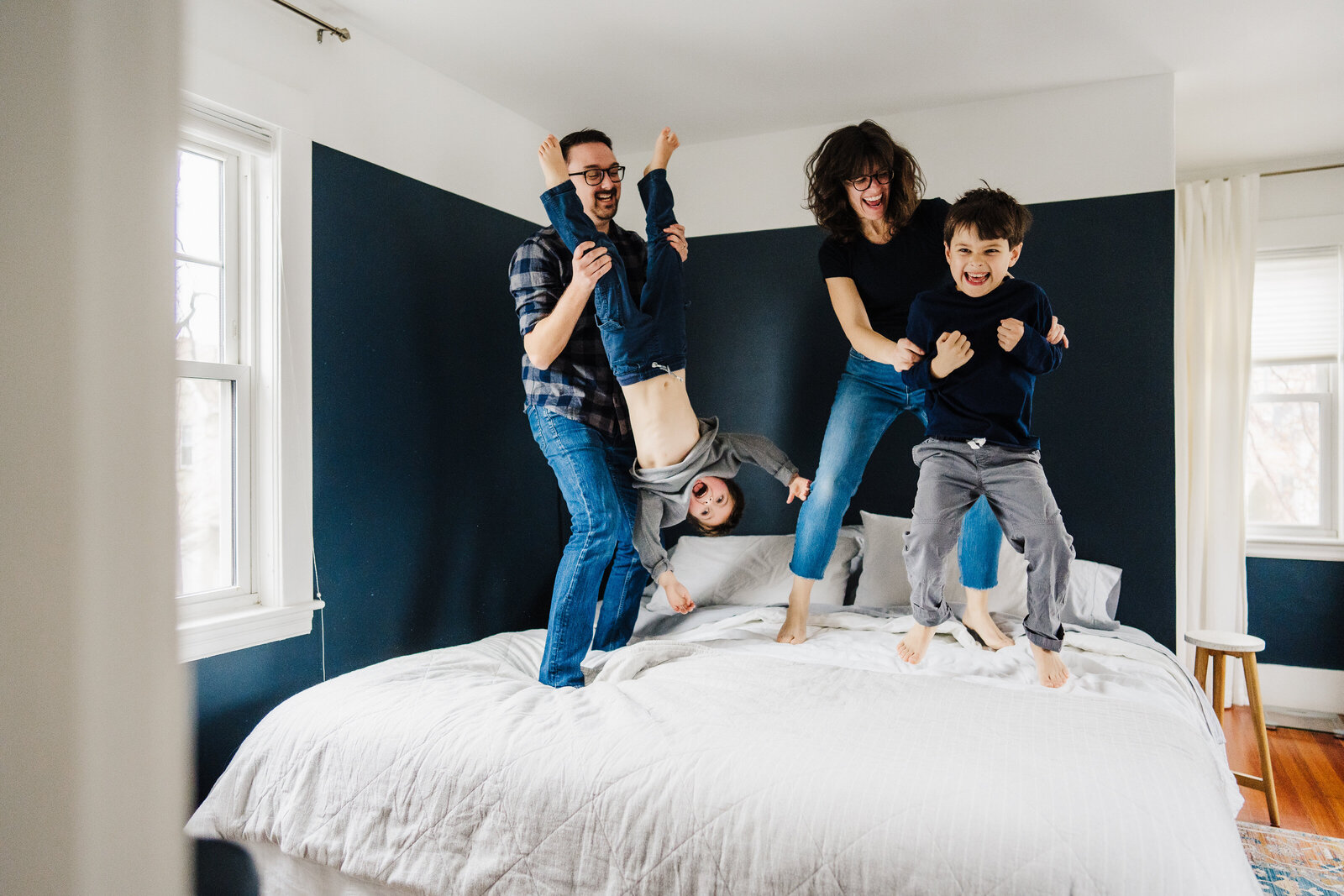 parents jump on bed with kids
