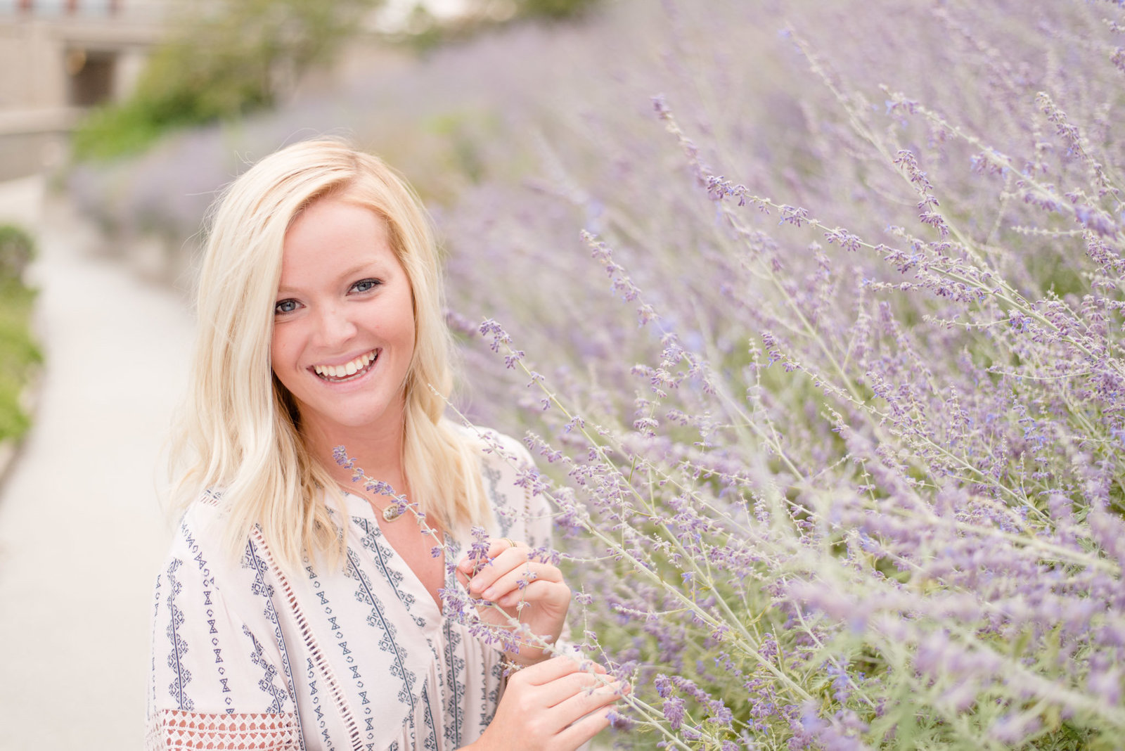 Girl holds lavender and smiles