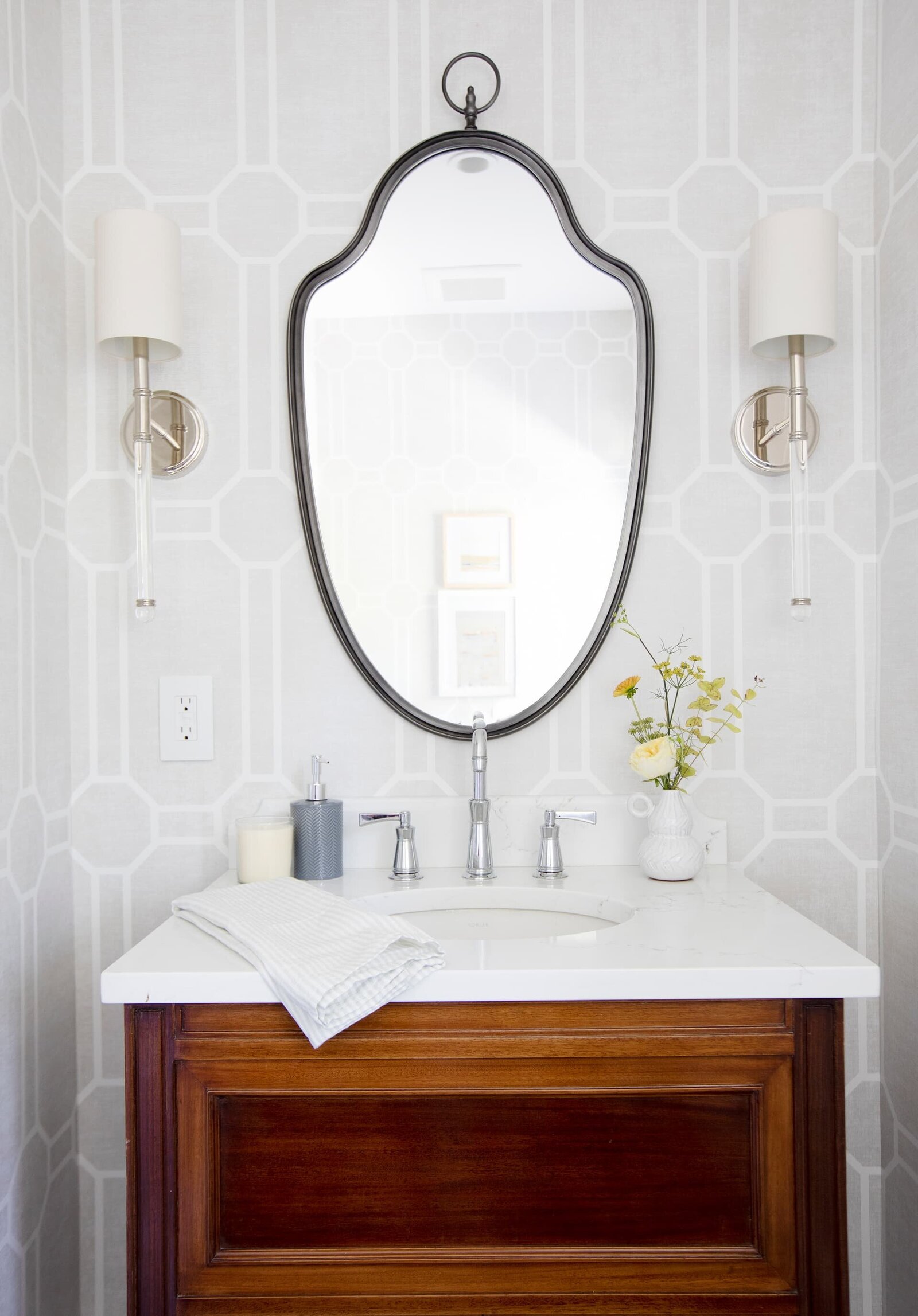 Granville Street l Powder Room with Trellis Wallpaper l Vintage Vanity with Black Mirror and pair of Lucite Wall Sconces