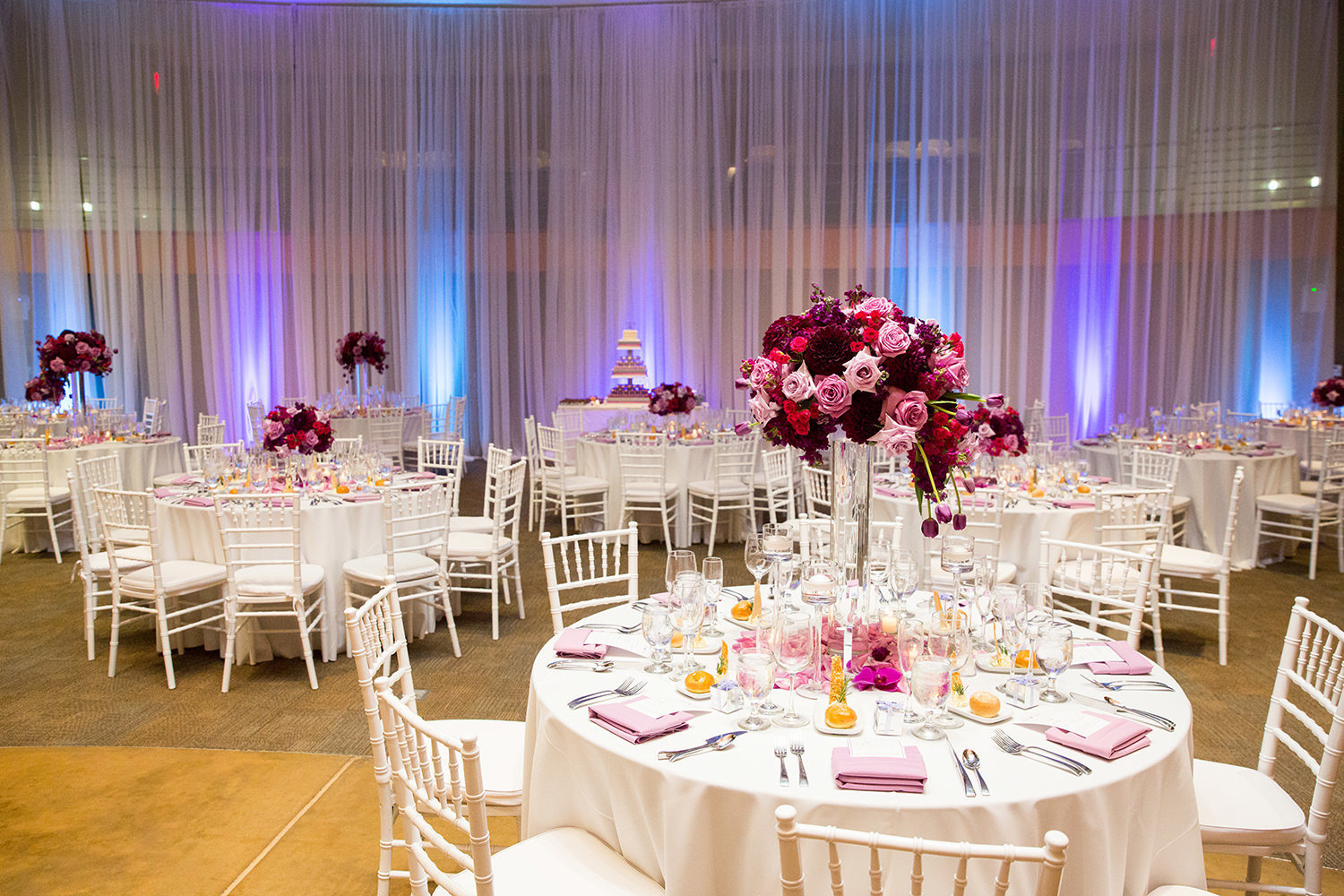 reception tables with pink and purple uplighting