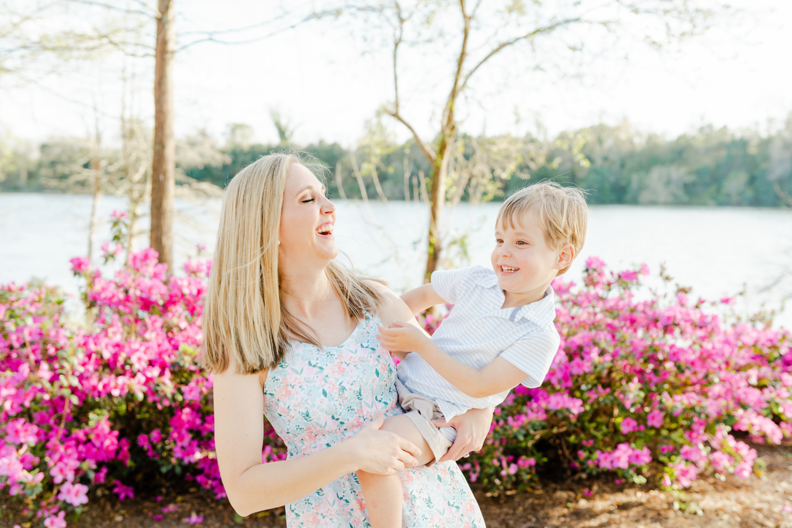 mom and toddler son swaying in front of pink blooms