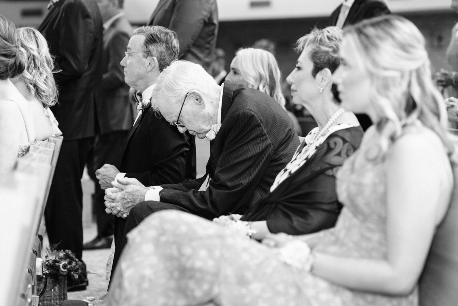 Old gentleman praying during wedding ceremony