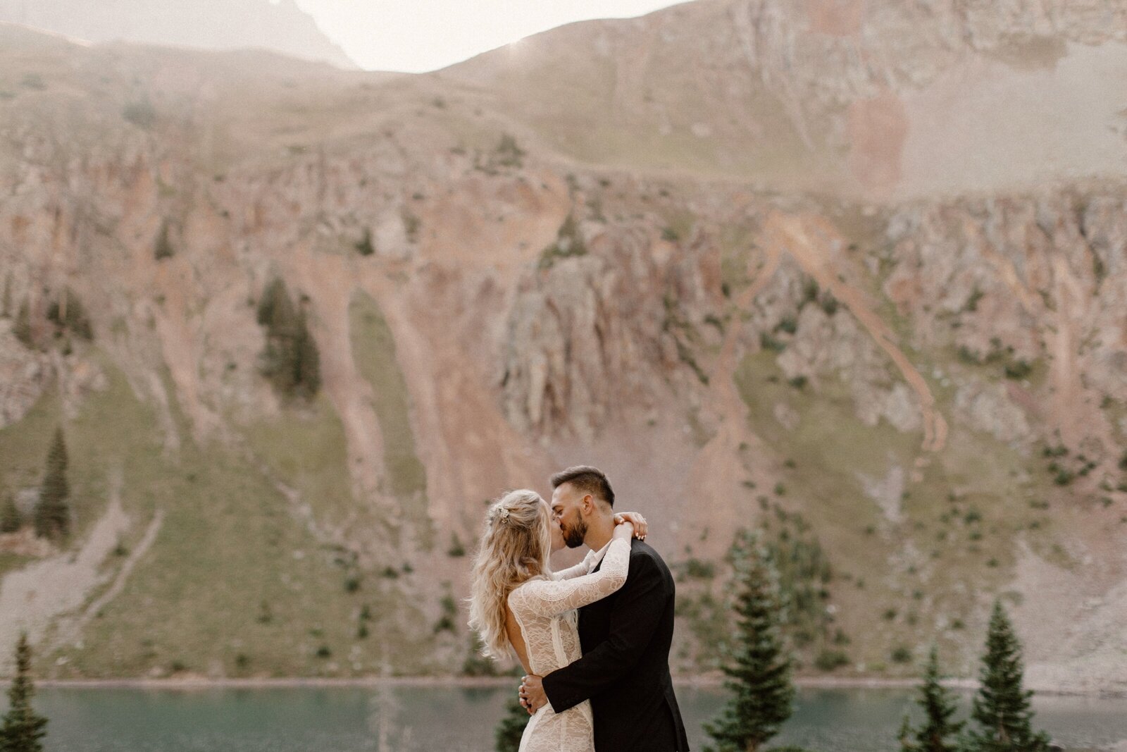 couple kissing at mountain elopement in valley