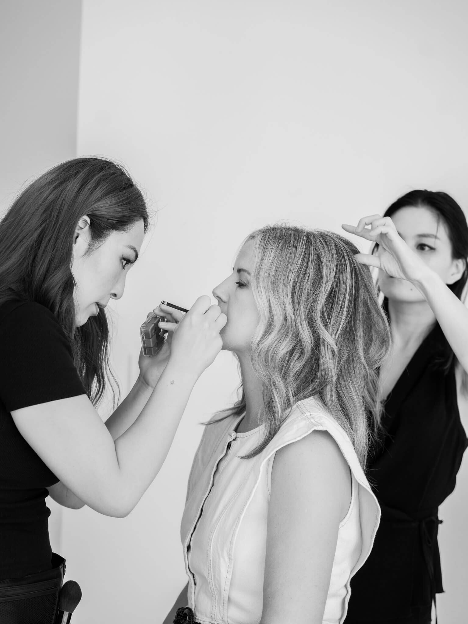 Two artists doing hair and makeup