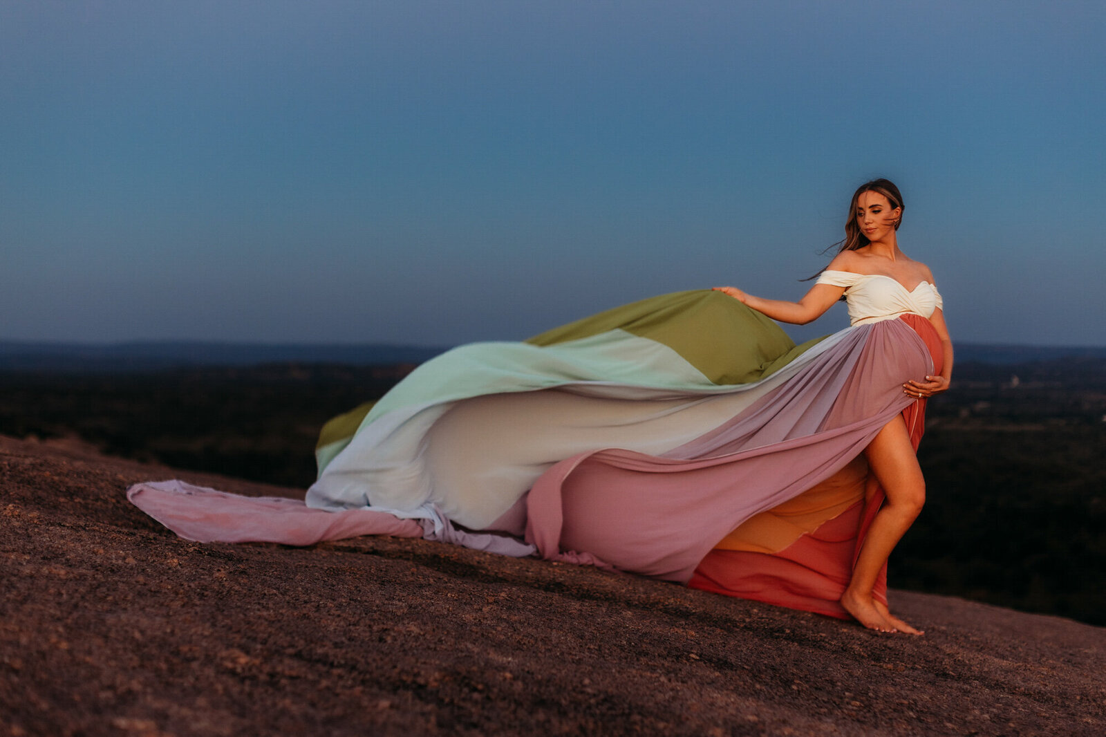woman in multi-colored dress for maternity photo session