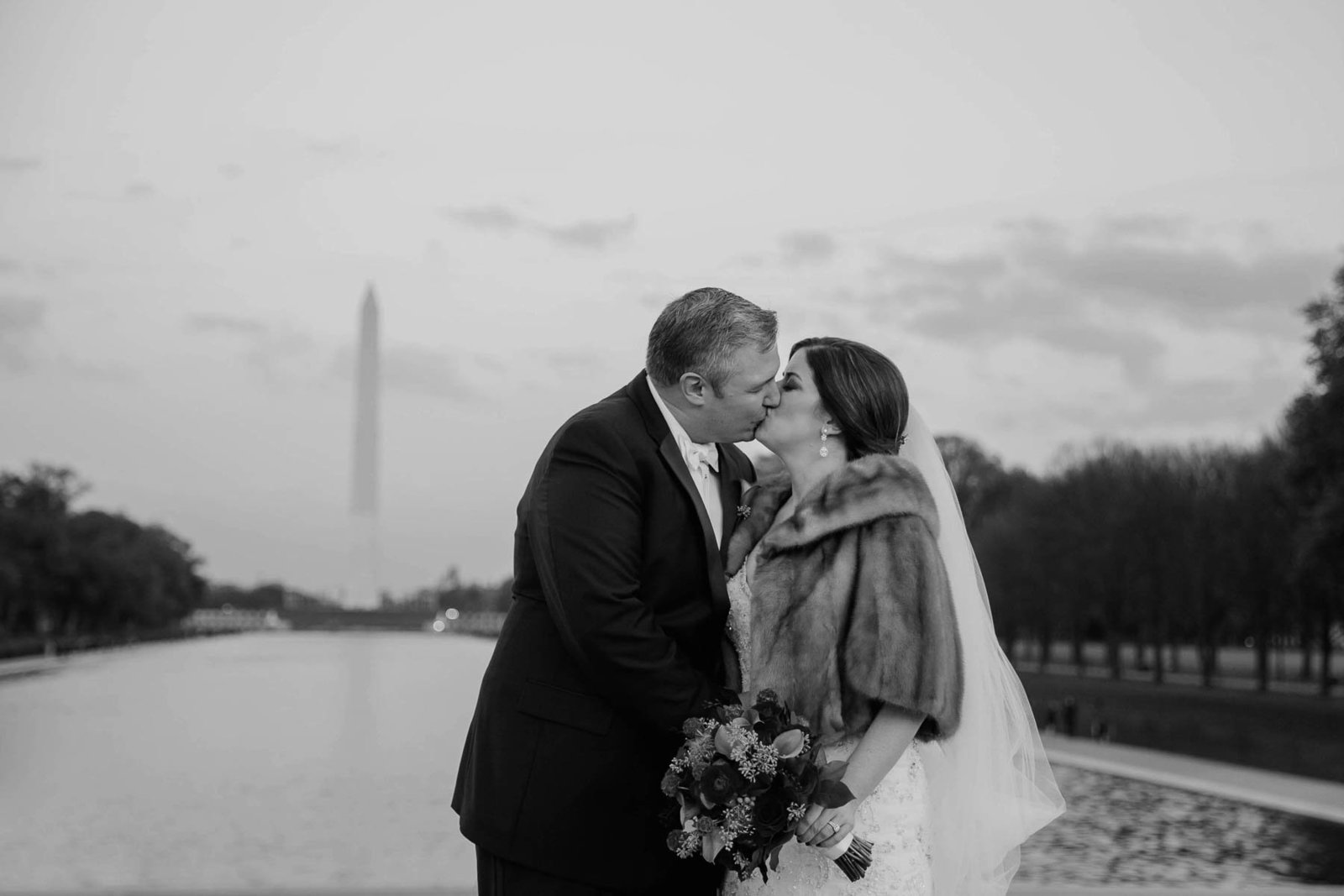 Bride and groom stand together, Washington Monument, National Mall, DC
