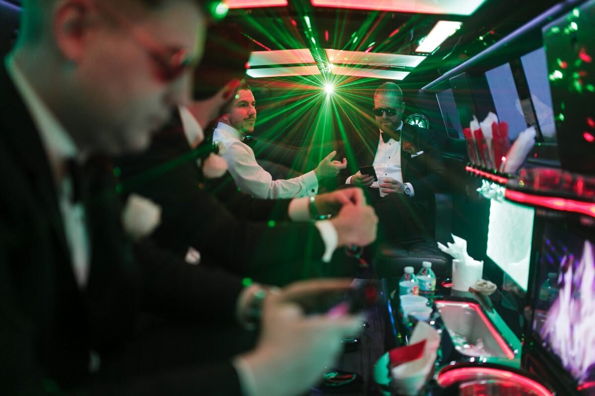 Groom and wedding party in a limo with party lights on the way to the ceremony