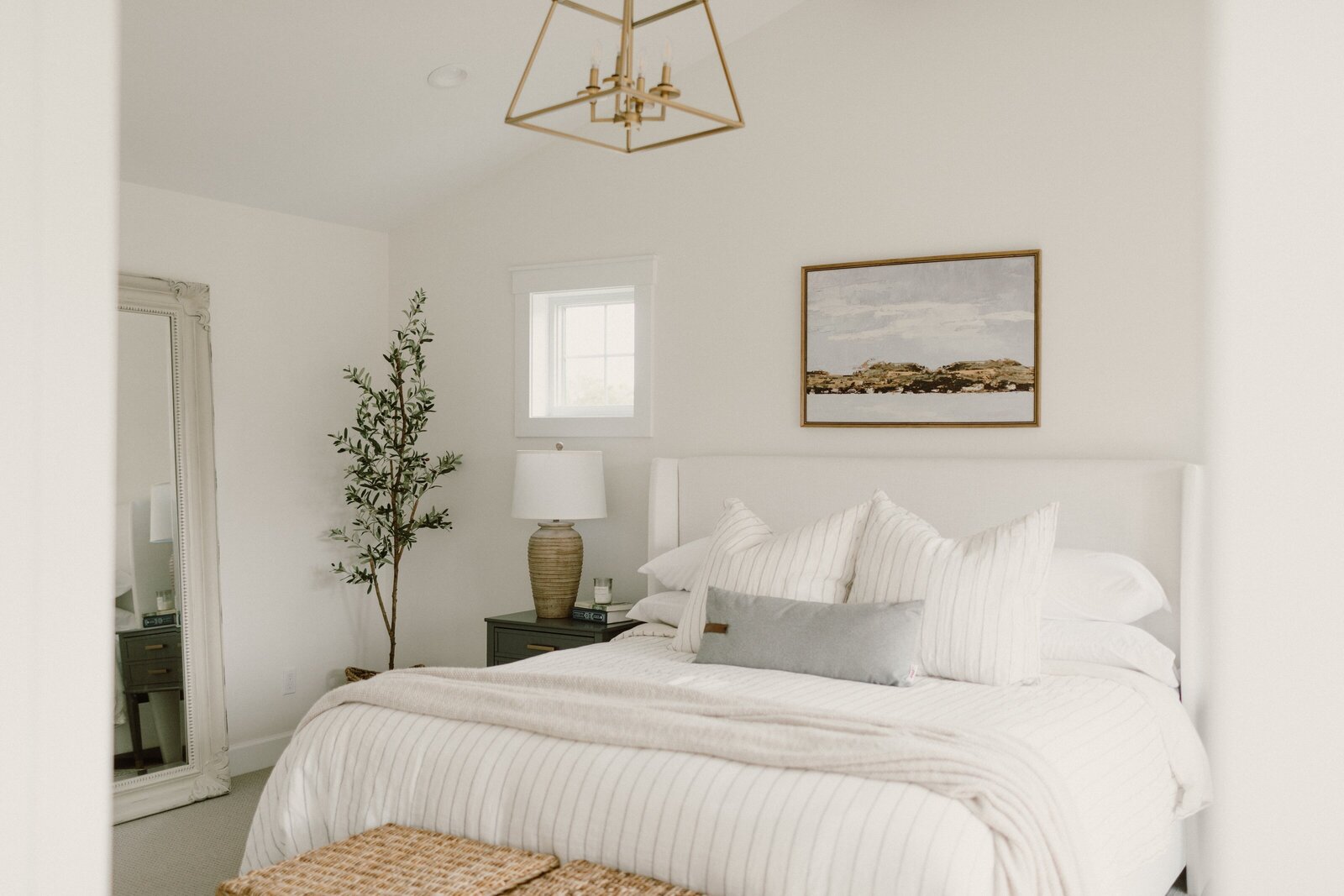 bright white master bedroom with artwork