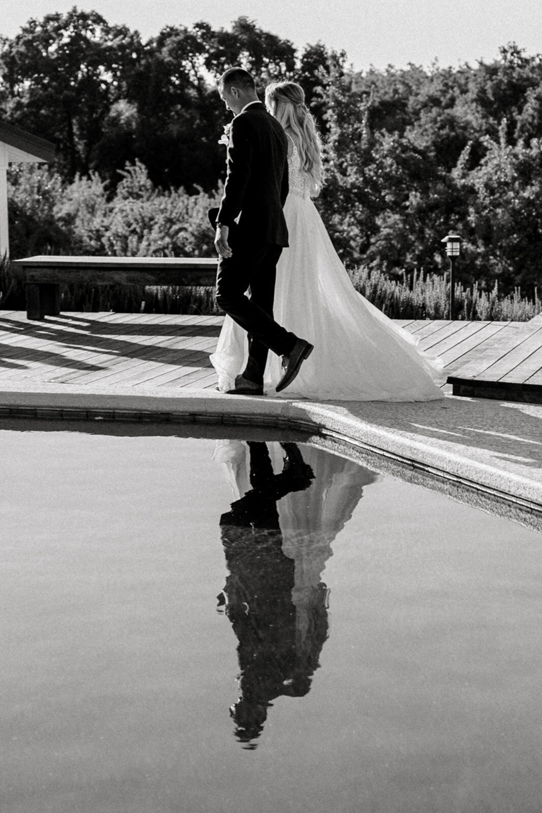 Bride and groom waling by water at The Maples wedding in Woodland, CA