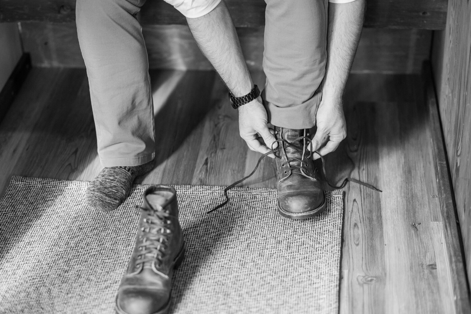 Man tying Red Wing boots on elopement day