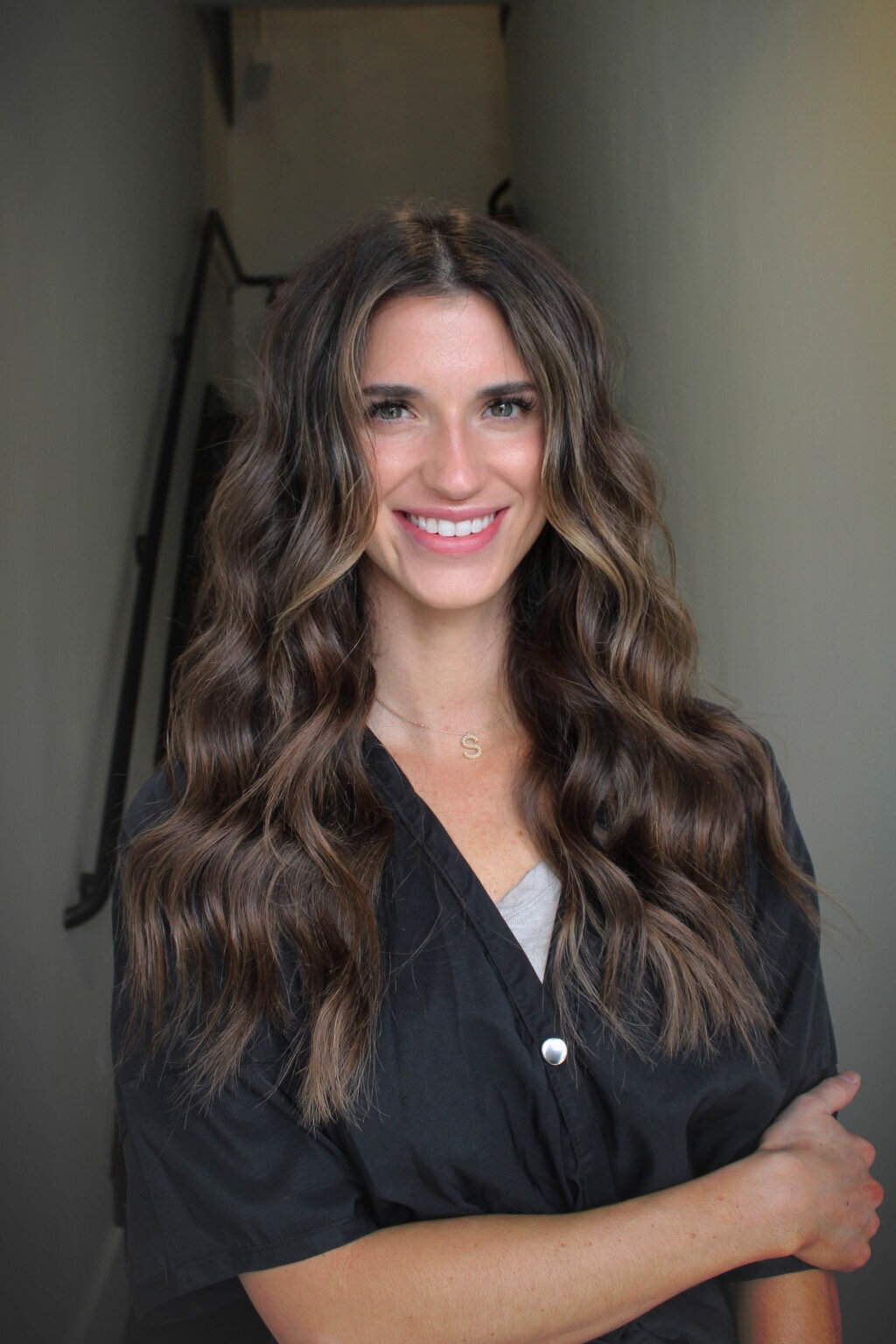 Smiling woman with long, voluminous brunette waves