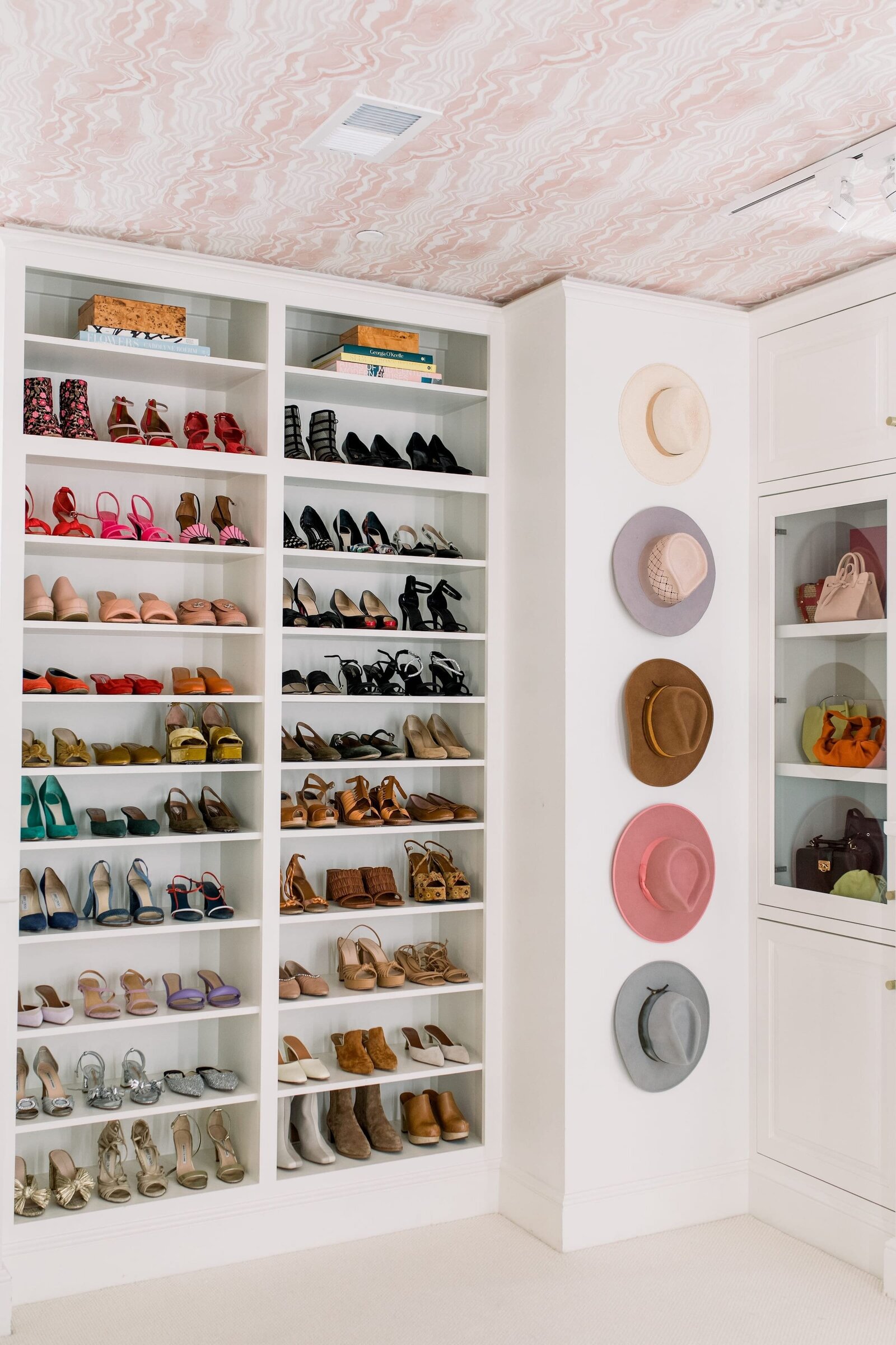 vision and hammer womens closet with shoes and hats on wall