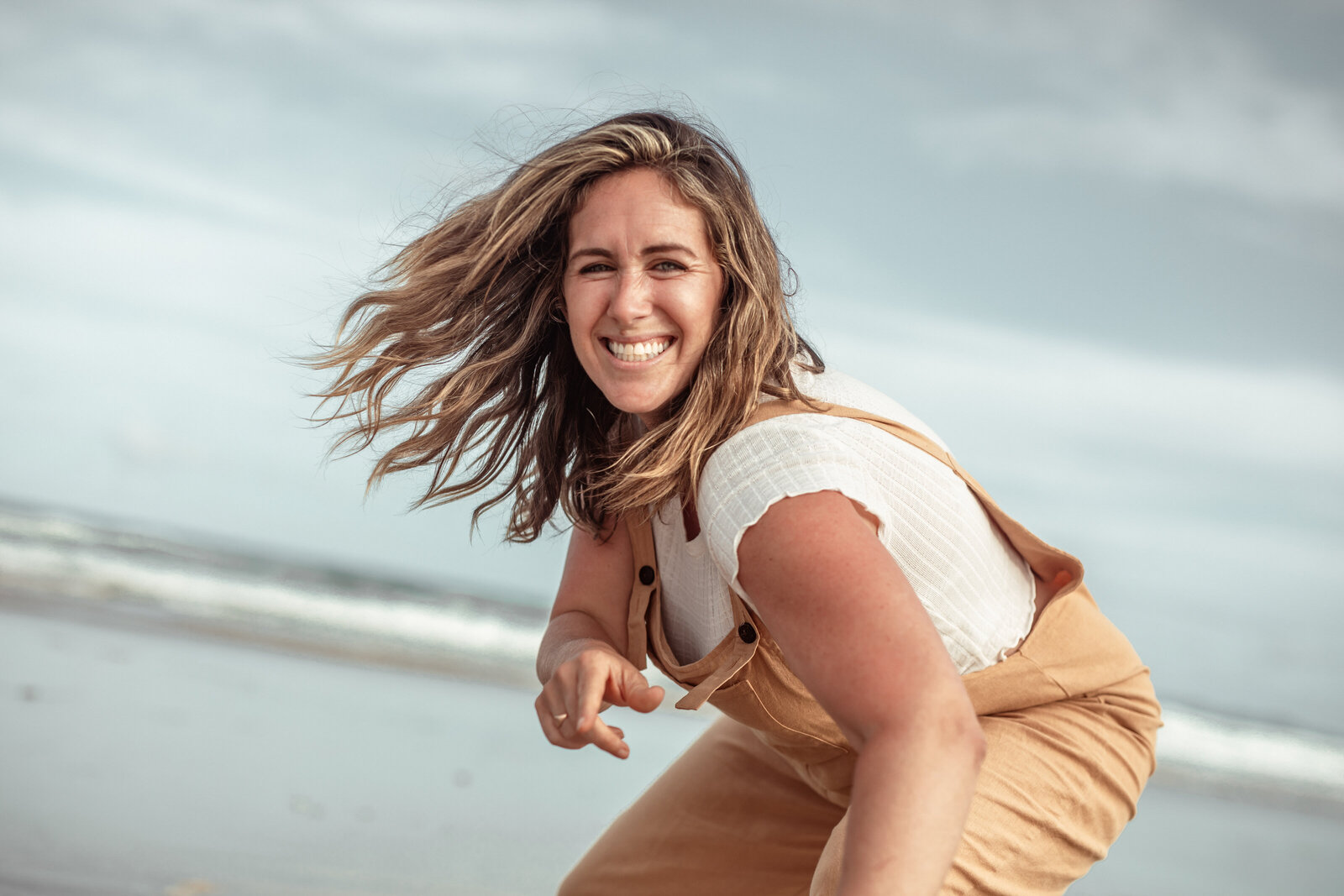 Joyful woman enjoying the beach with a big smile