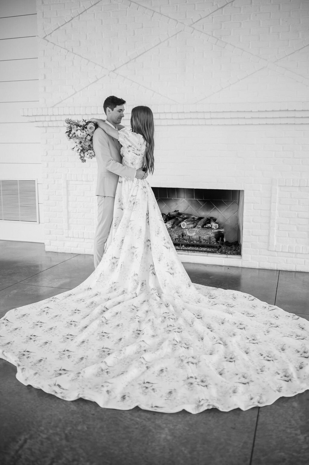 Bride wearing a floral printed wedding dress with a long, dramatic train