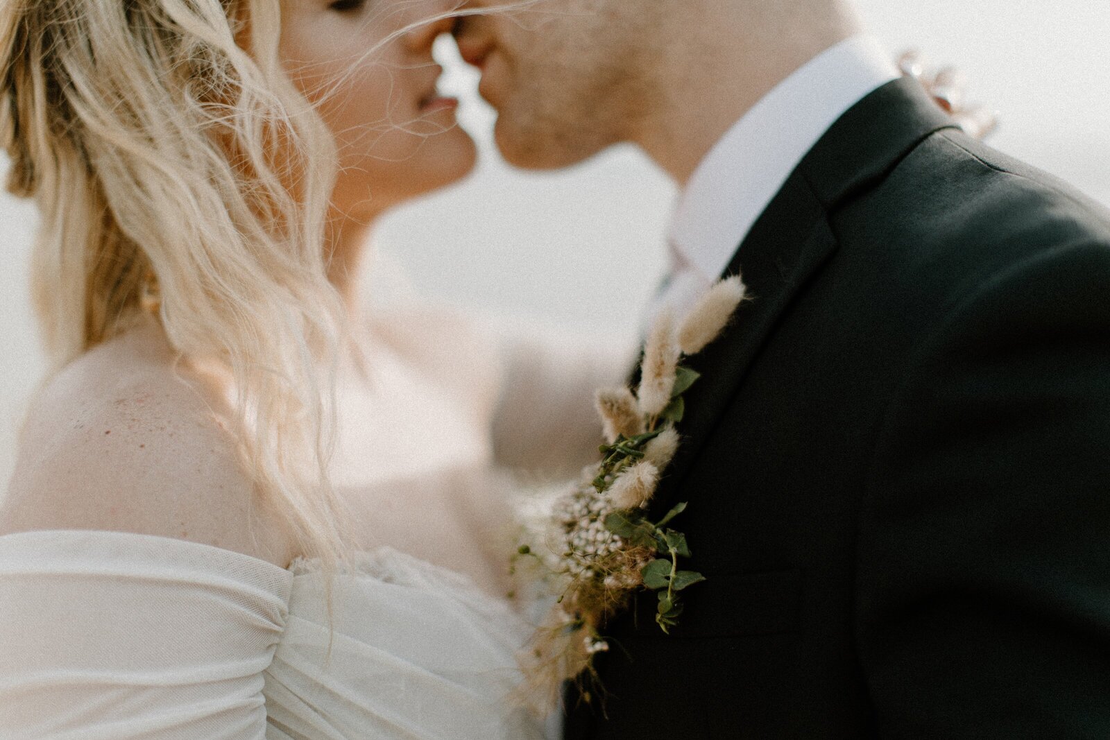 detail of bride and groom kissing close up