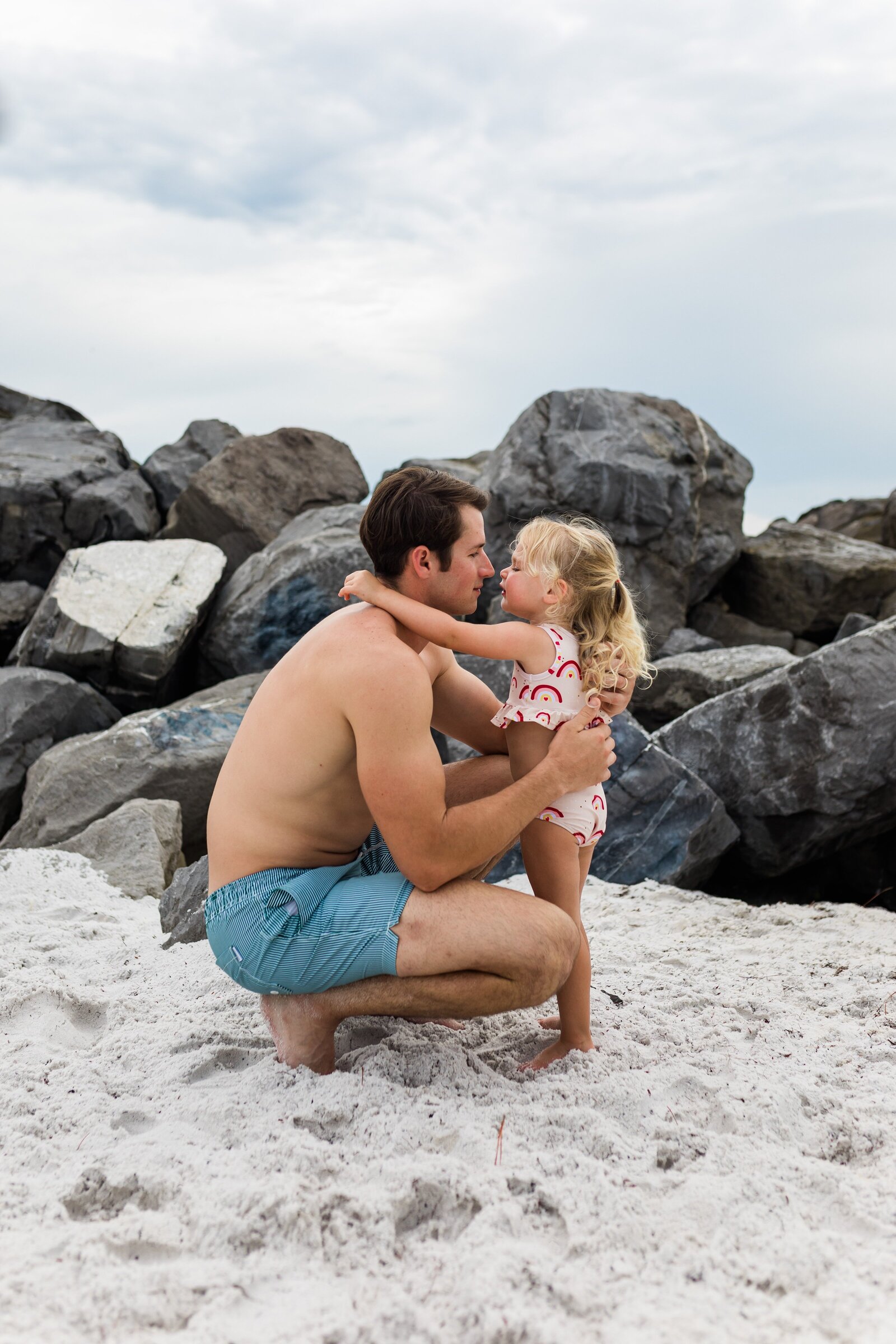 Pensacola Beach  vacation family photo session . Family playing in the sand.