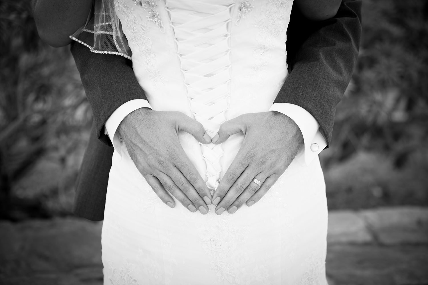 bride and groom romantic image at coronado community center heart with hands