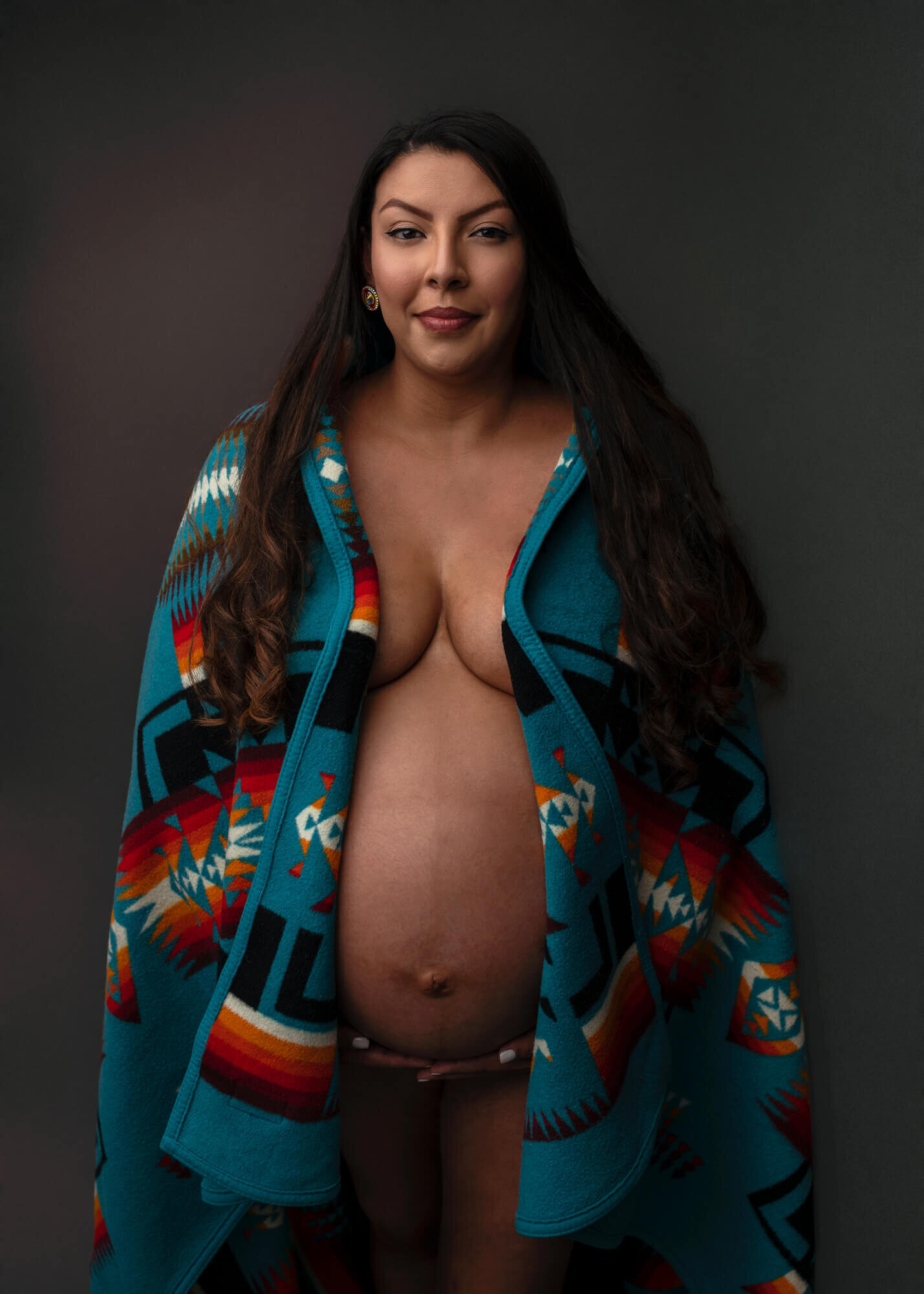 maternity portrait of a  native american woman with a Pendelton Blanket