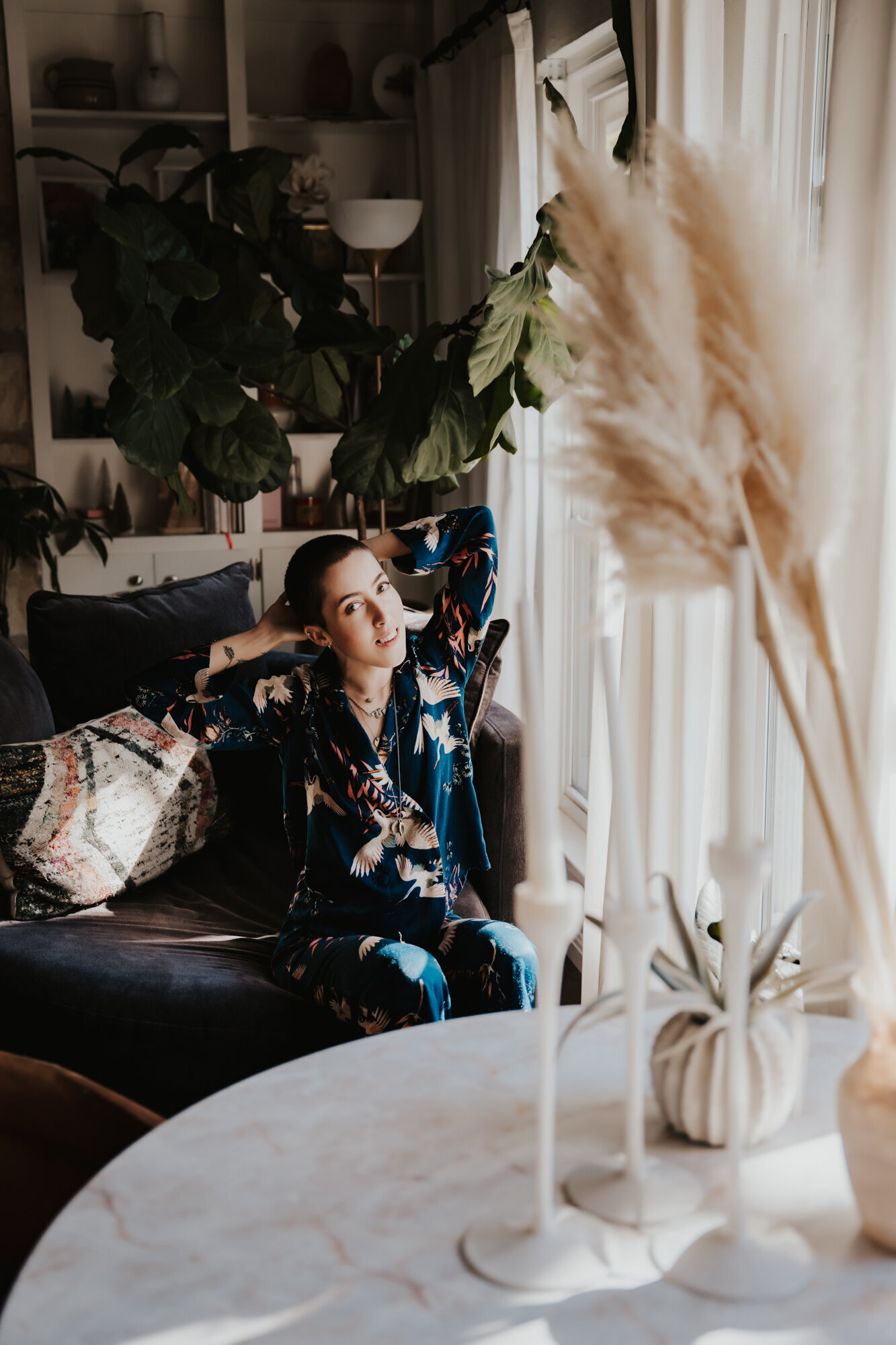 Branding Photographer,  a woman in a kimono sits in a large loveseat in he living room