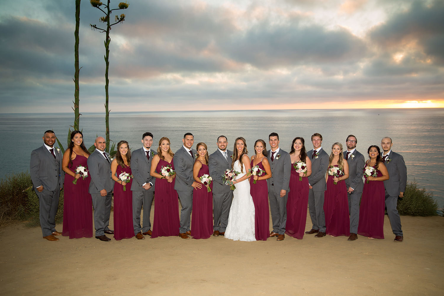 full bridal party photo with red dresses