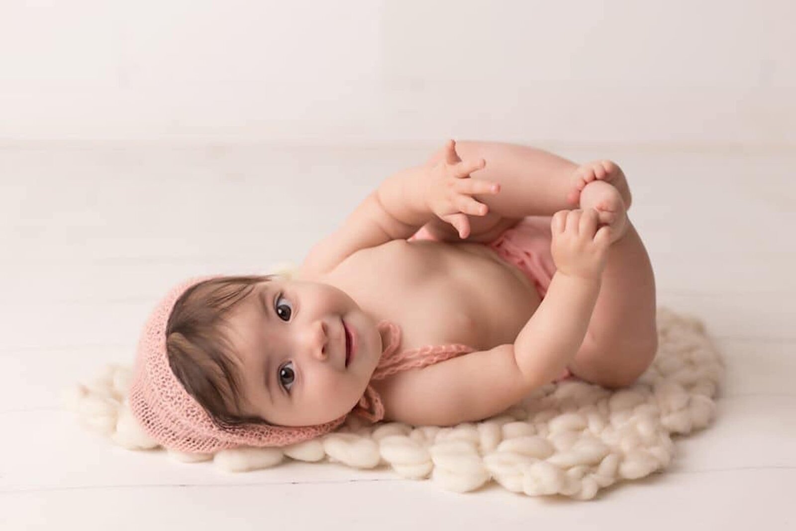 baby girl holding her toes in santa clarita photography studio