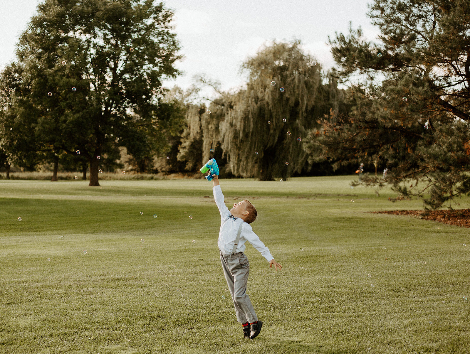 Ring bearer playing outside during a Minneapolis Wedding