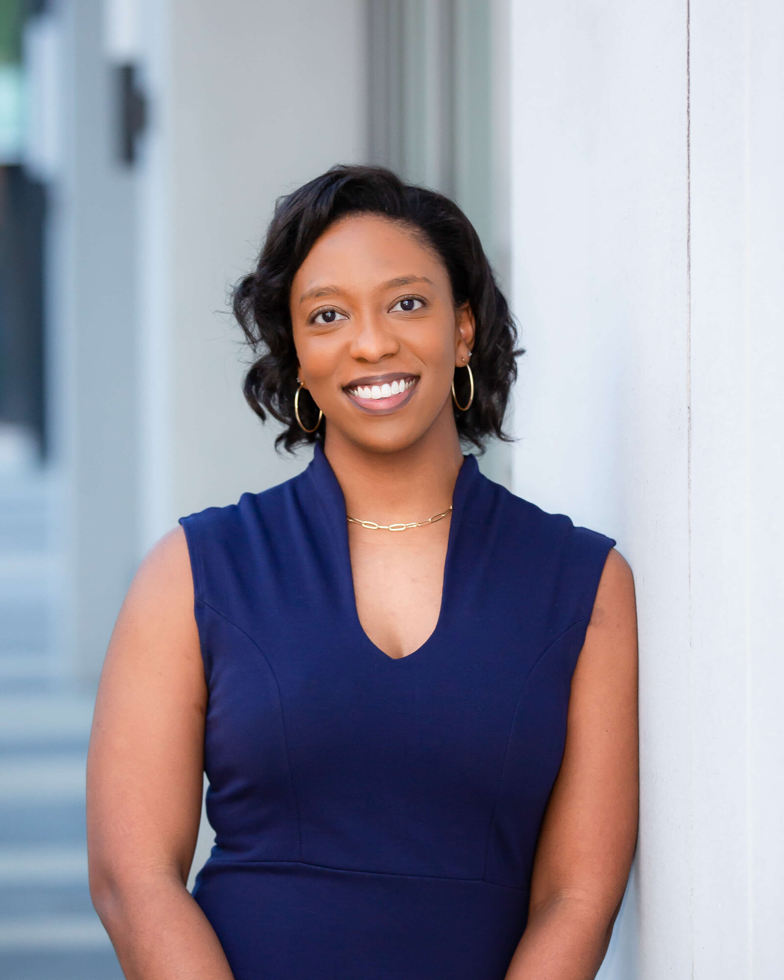 Corporate headshot of woman, a financial adviser at Merrill Lynch in Orlando, Florida. Captured with natural lighting to highlight a professional and approachable demeanor.