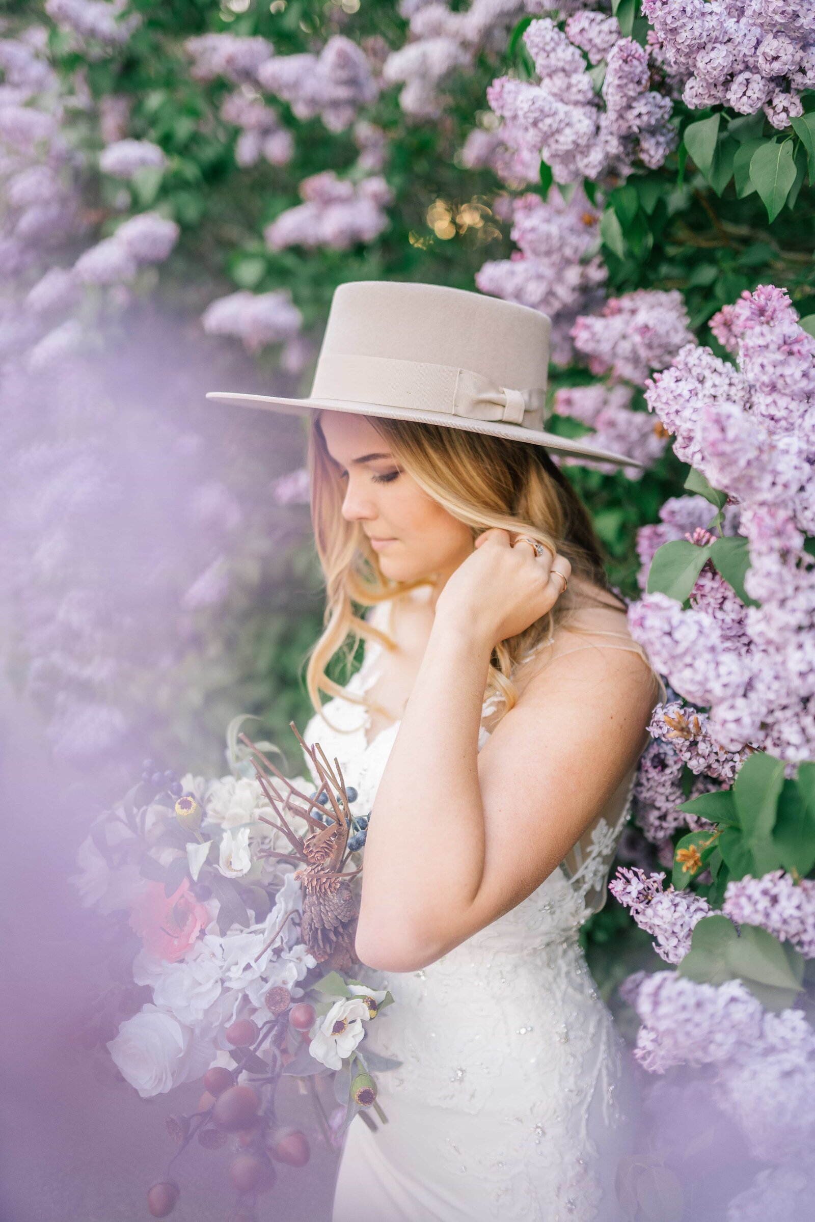 bride with hat next to purple blossoms in Knoxville Tennessee