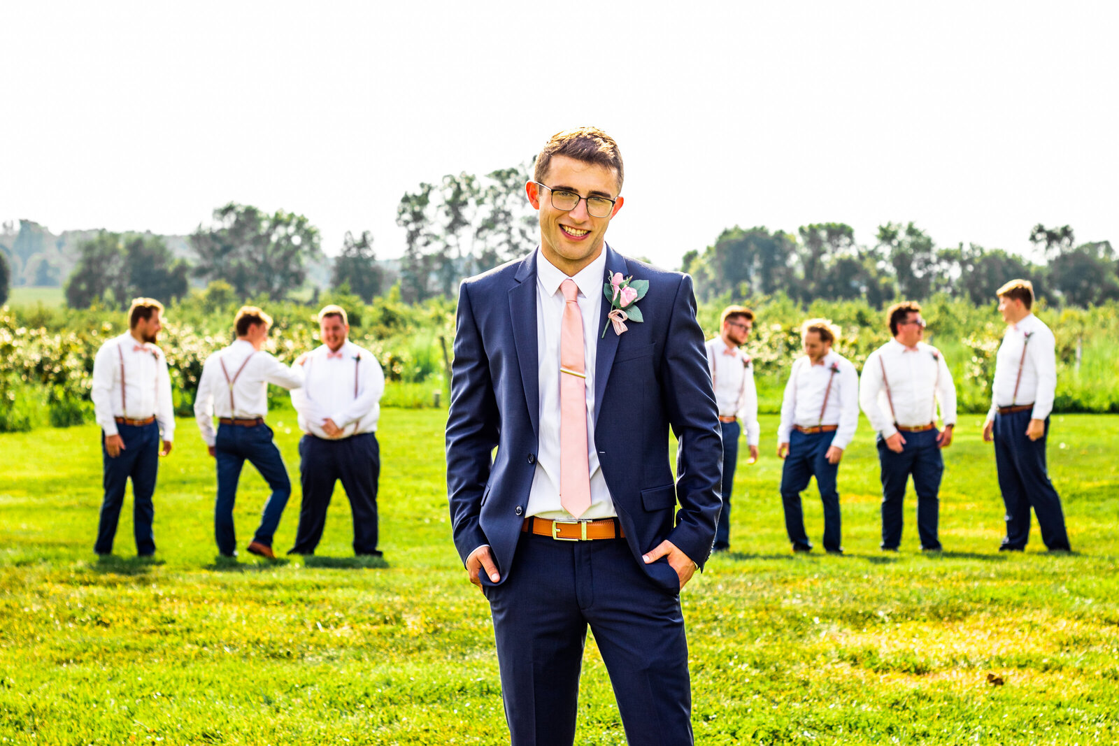 Groomsmen photos outside in a field at The Cherry Barc Farm. Photos by Devin Ramon Photography.