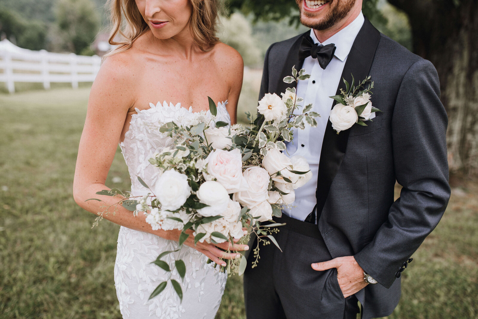 A deatil shot of a bride and groom with whit green and blush wedding flowers