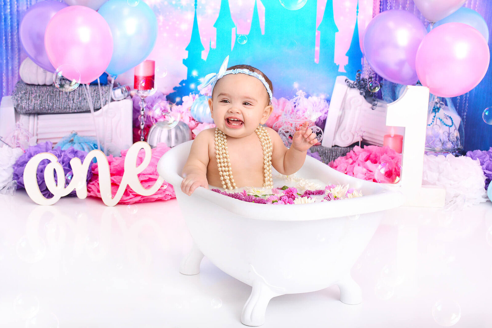 girl smiles at her first birthday photoshoot in houston texas