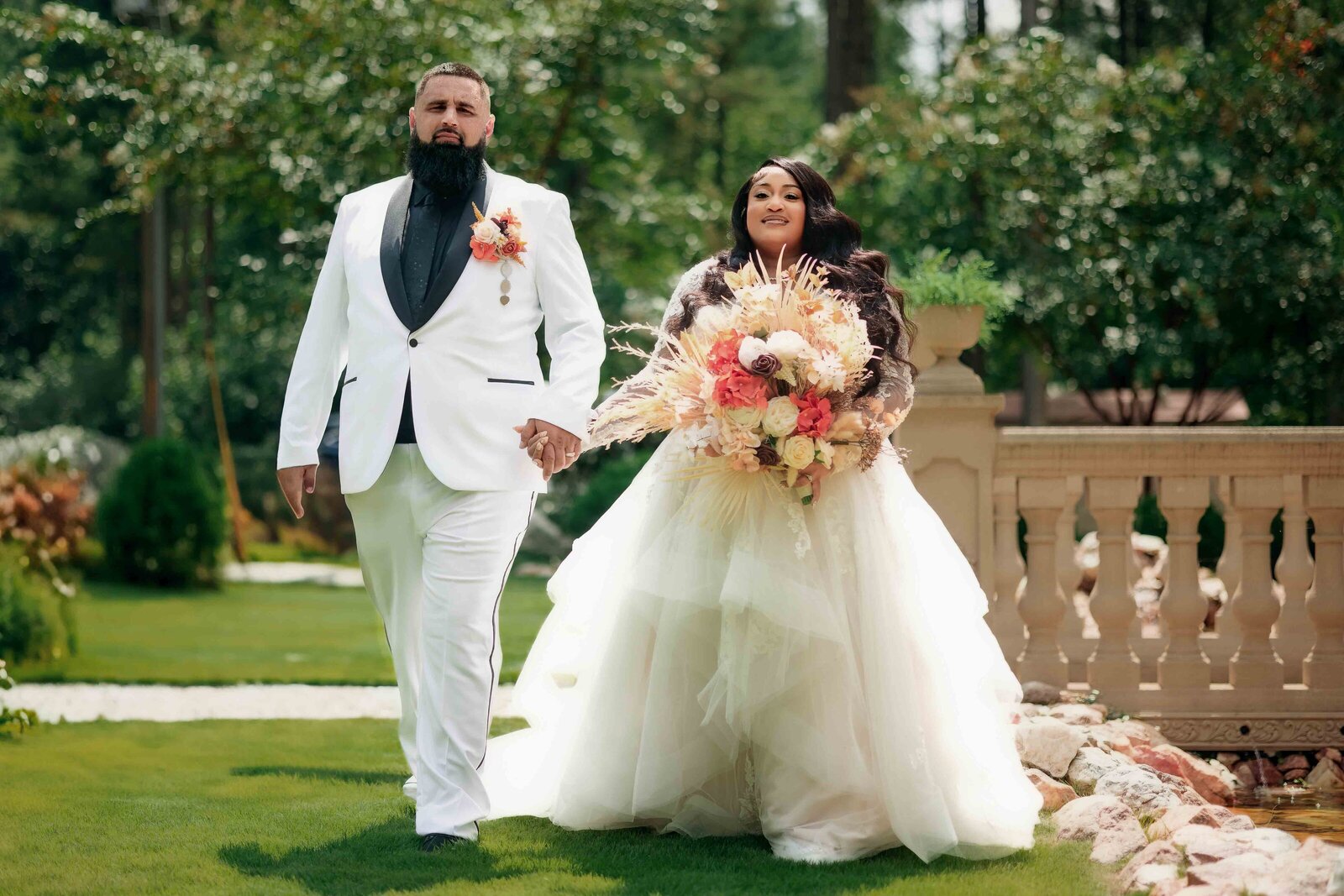 wedding couple walking during their wedding portraits at castle-at-wildwood-gardens