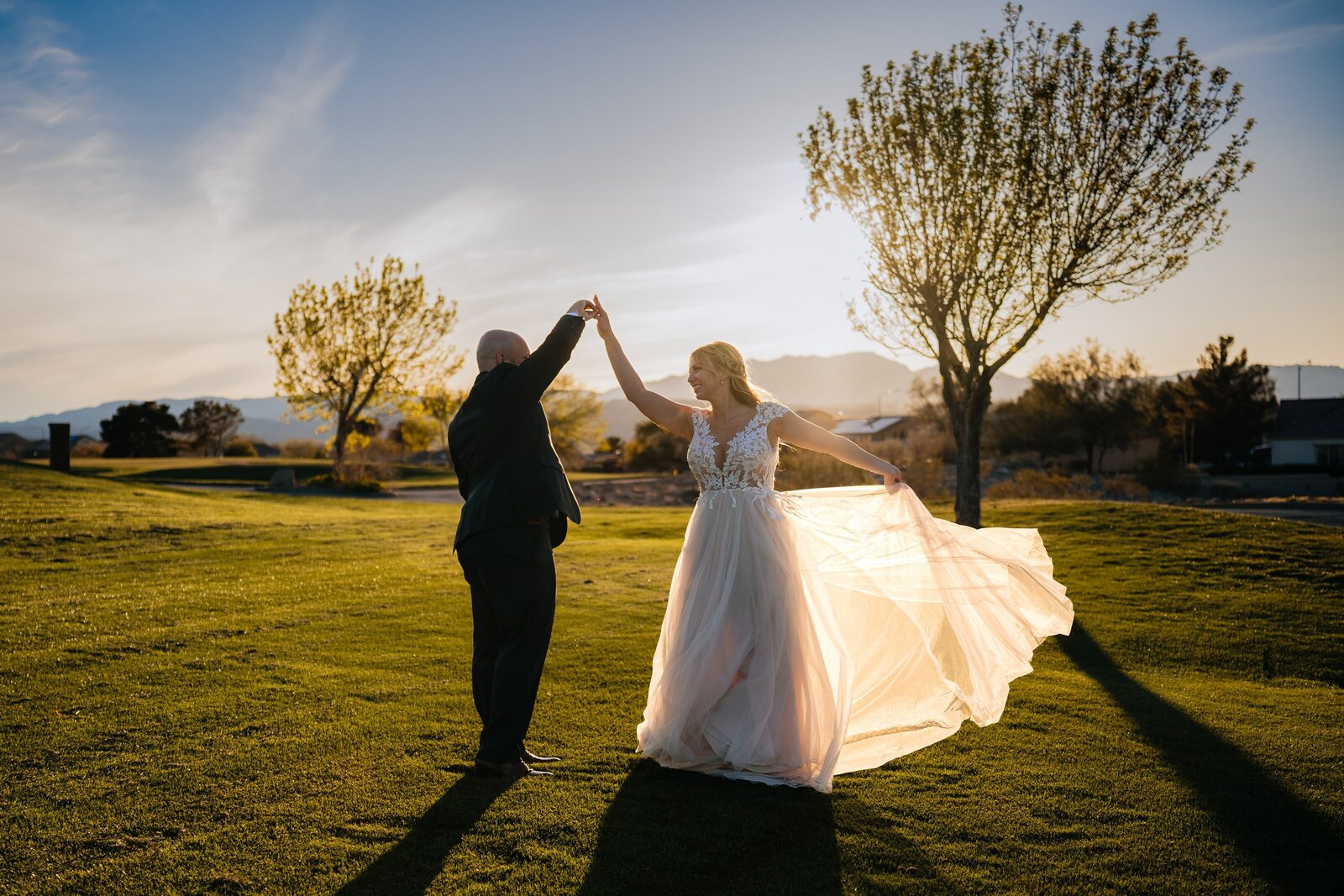 A newlywed couple dancing in the enchanting sunset at Revere Golf Club.