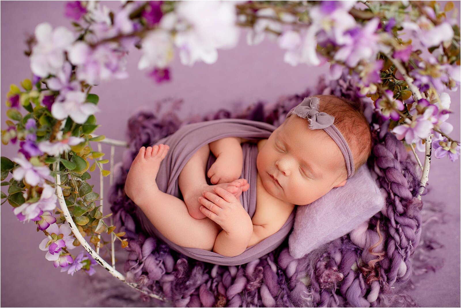 newborn baby girl in purple