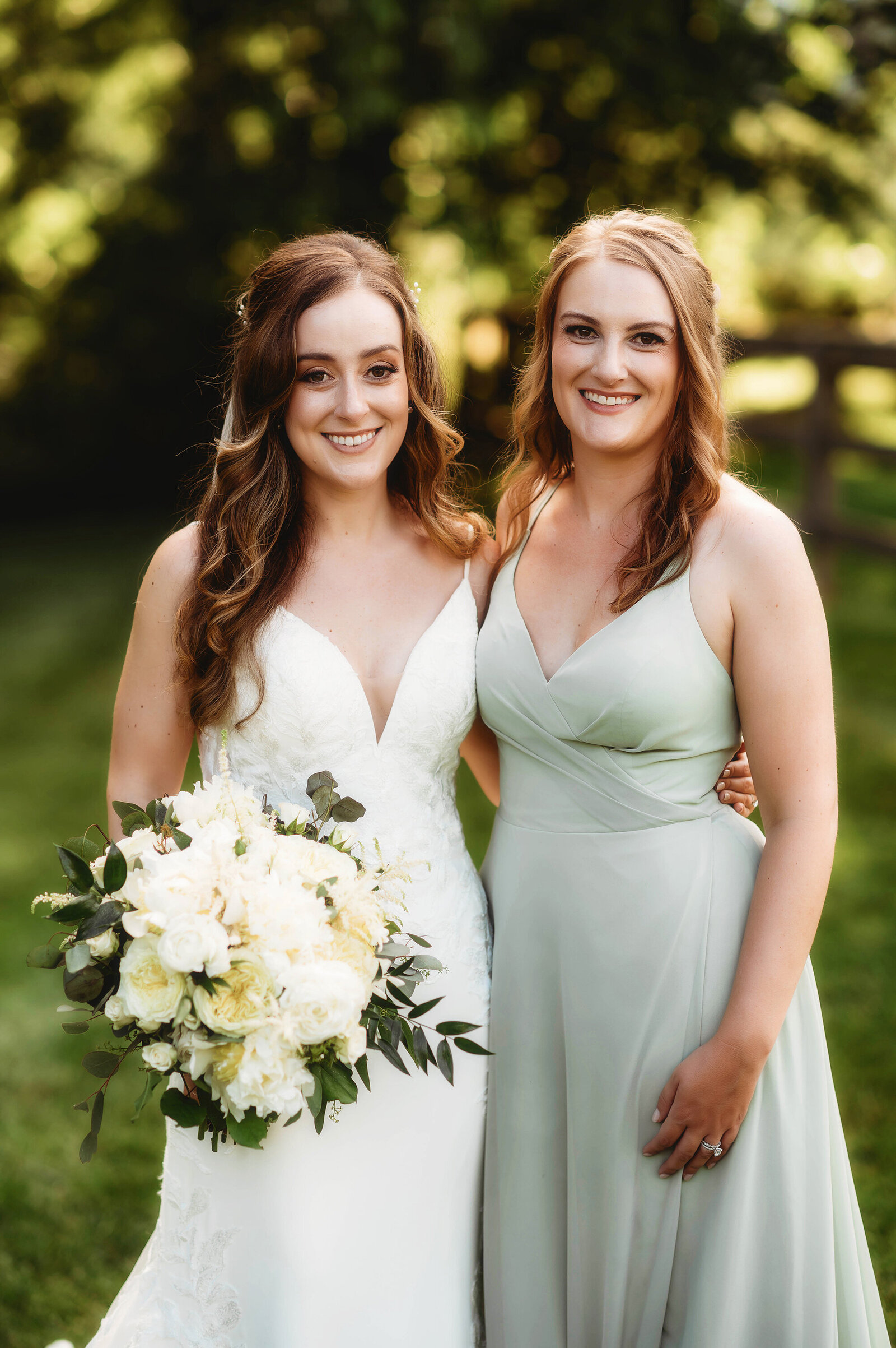 Bride poses with her sister before her Micro-Wedding Ceremony at The Farm in Asheville, NC.