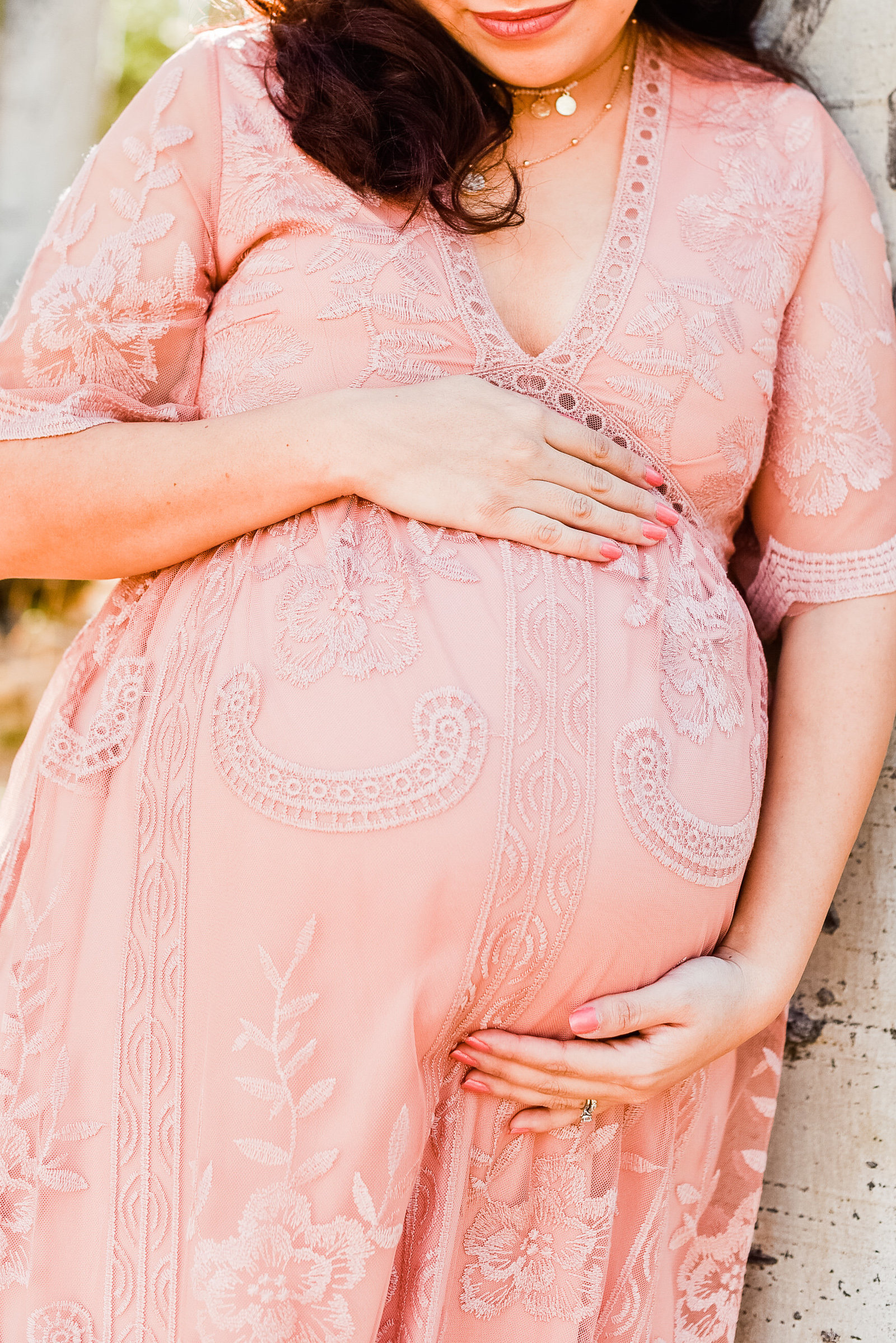 Pregnant women holding belly pregnancy announcement Flagstaff Arizona Snowbowl
