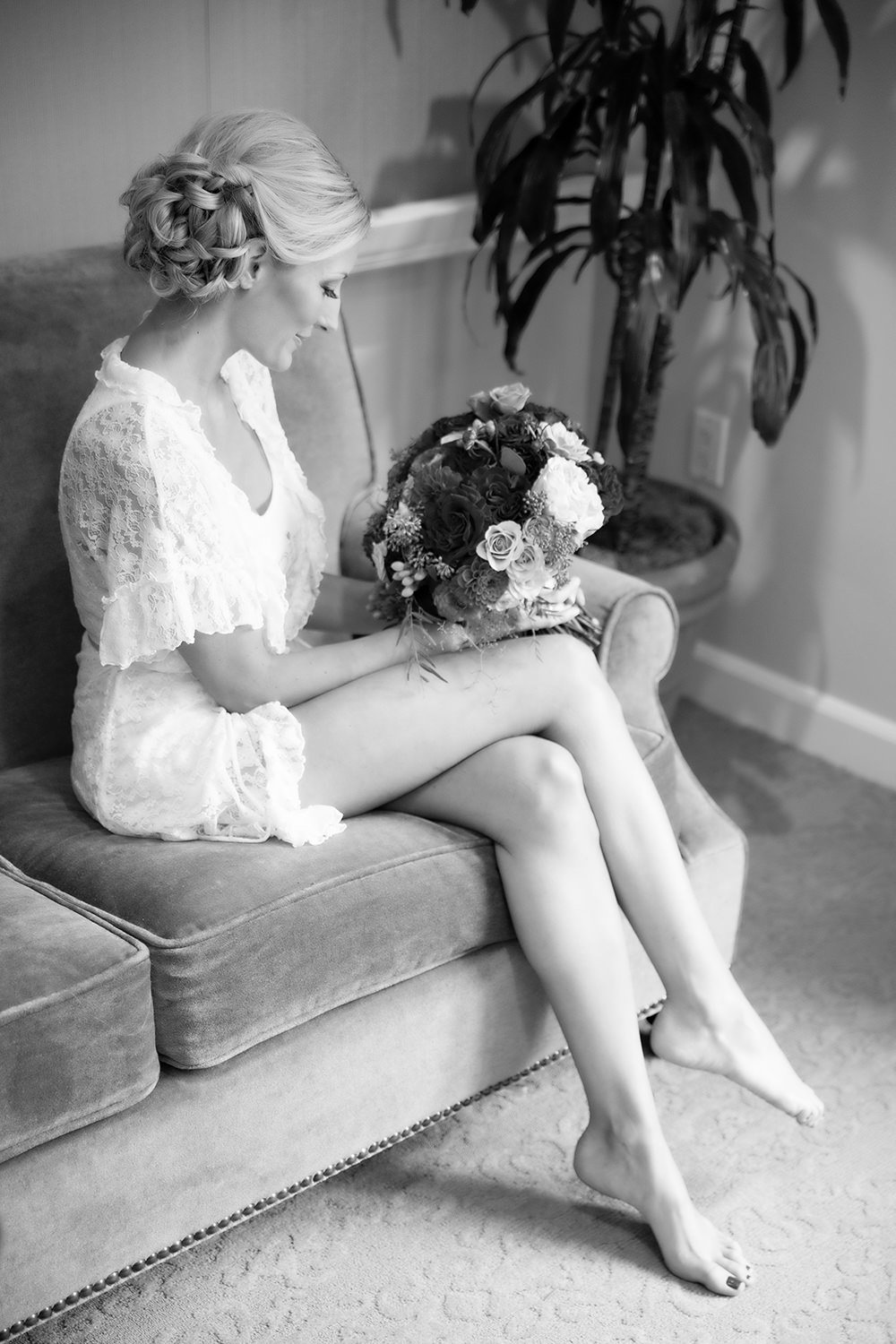 Elegant moment captured in black and white of a bride getting ready