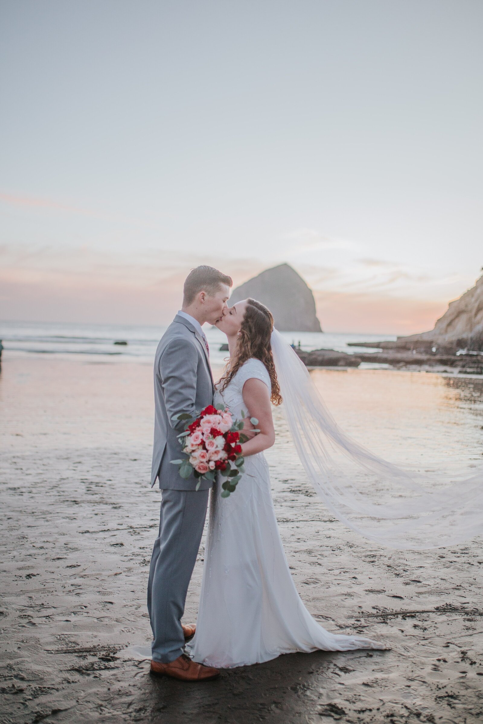 Sacramento Wedding Photographer captures bride and groom kissing on beach during beach bridals