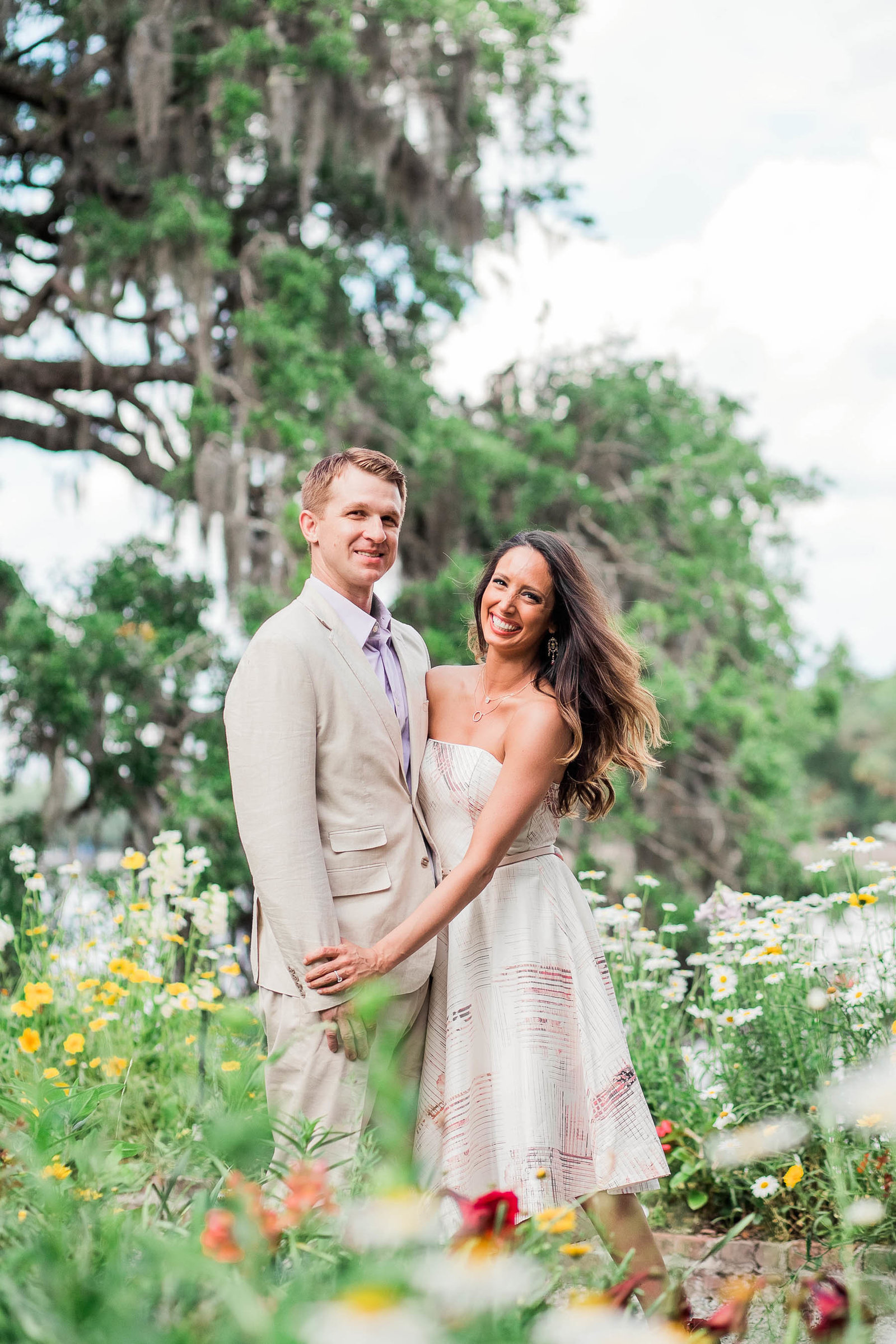 Engaged couple stand among wildflowers, Magnolia Plantation, Charleston, South Carolina