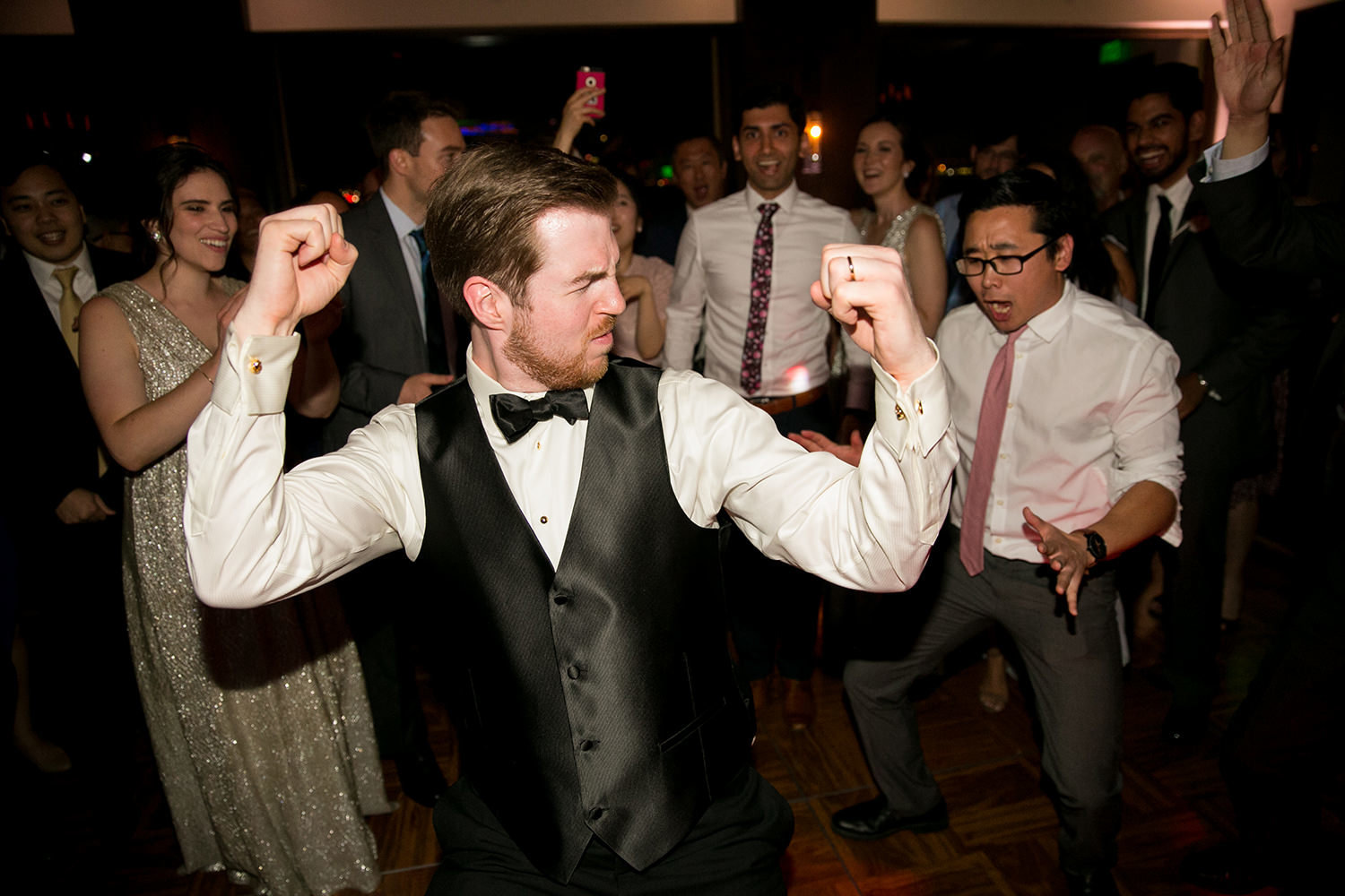 groom dancing at reception being silly