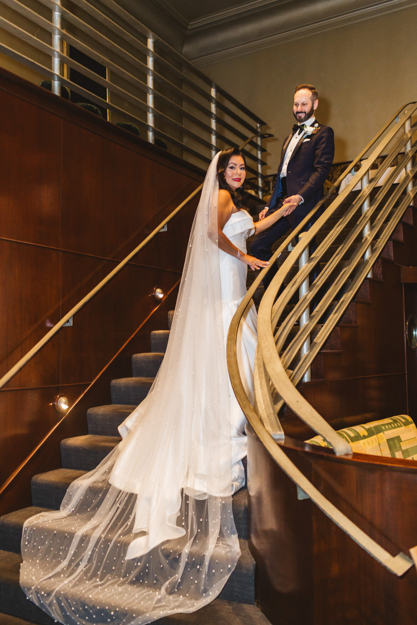 bride and groom on staircase of Bix