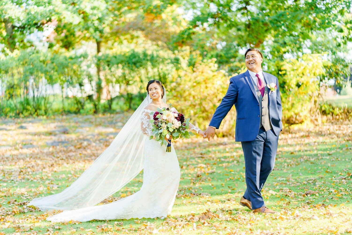 New Hampshire bride and groom holding hands and laughing