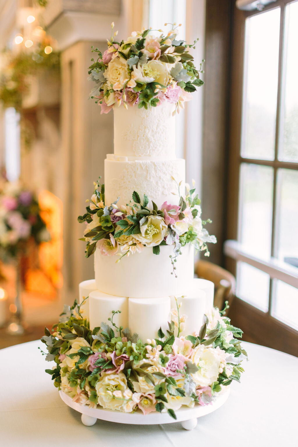 White three tiered wedding cake with flowers