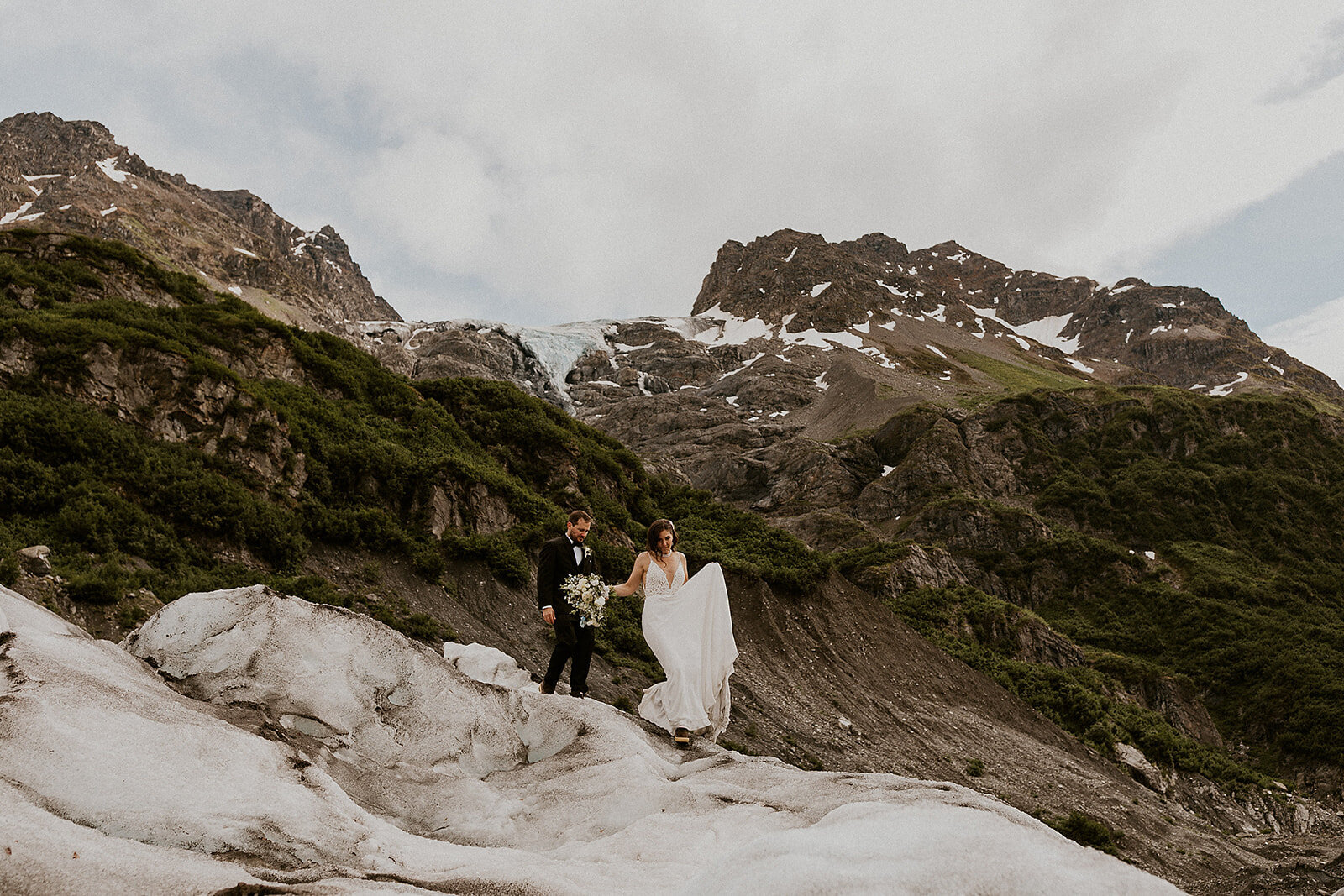 bride and groom on glacier